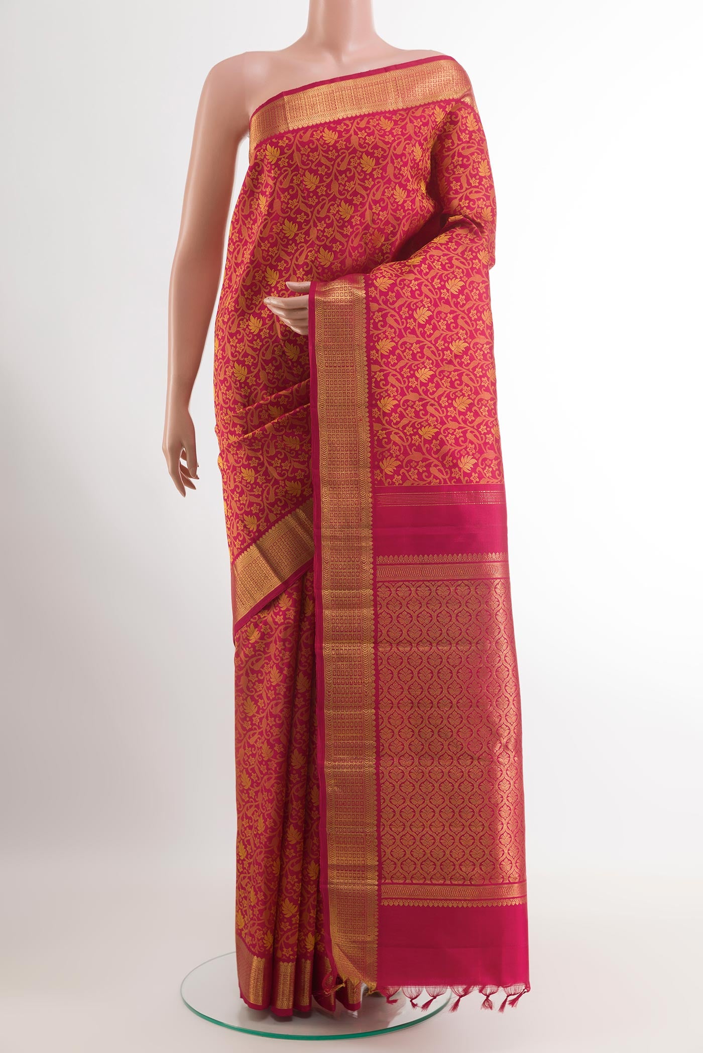 Red Kanjivaram Silk Saree with Jacquard design on the body and Zari Border.  displayed on a mannequin