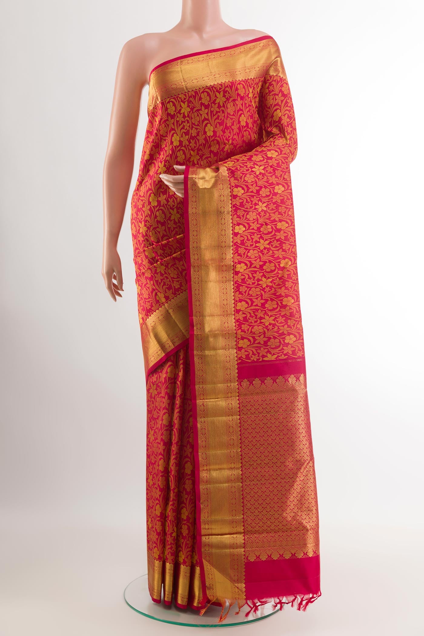 Red Kanjivaram Silk Saree with Jacquard design on the body and Zari Border.  displayed on a mannequin