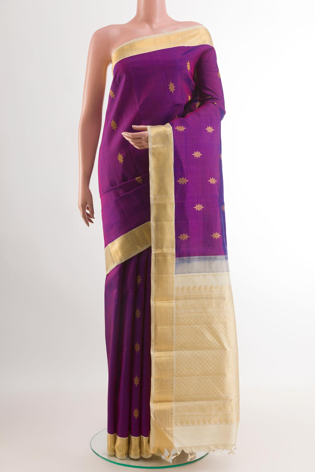Purple Kanjivaram Silk Saree with Zari Butta on the body and Zari Border.  displayed on a mannequin