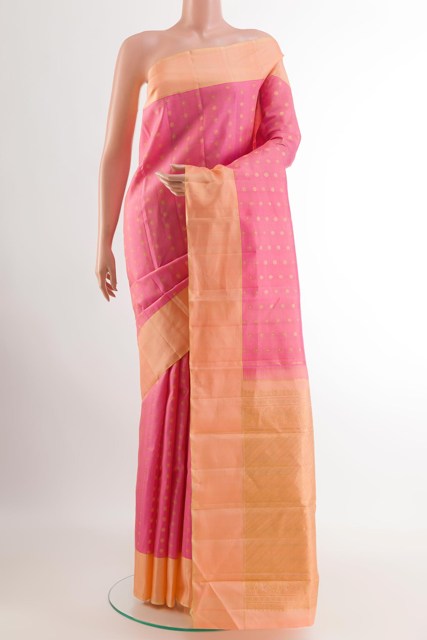 Pink Kanchipuram Silk Saree with Zari Butta on the body and Zari Border.  displayed on a mannequin