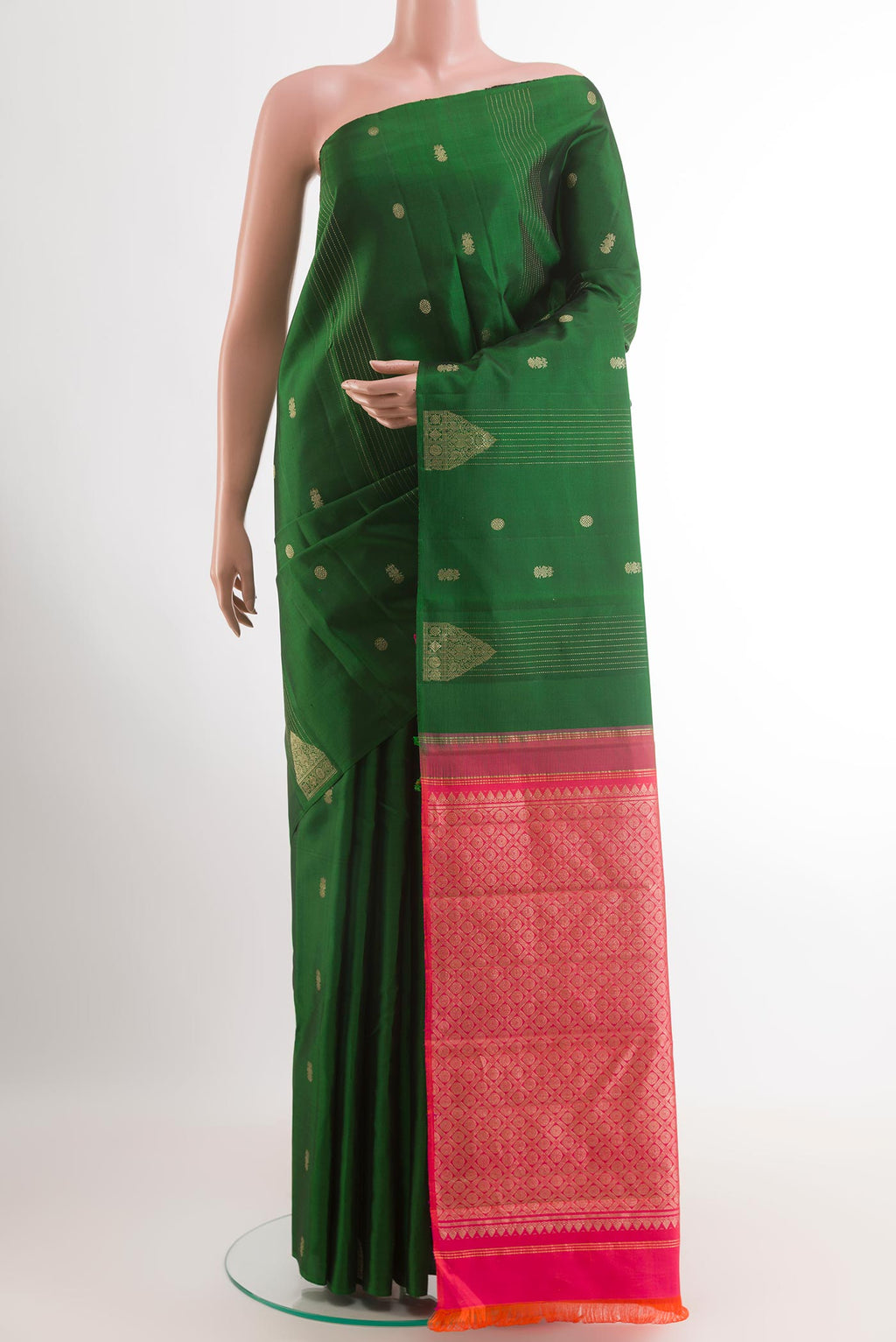 Green Kanchipuram Silk Saree with Zari Butta on the body and Zari Border.  displayed on a mannequin