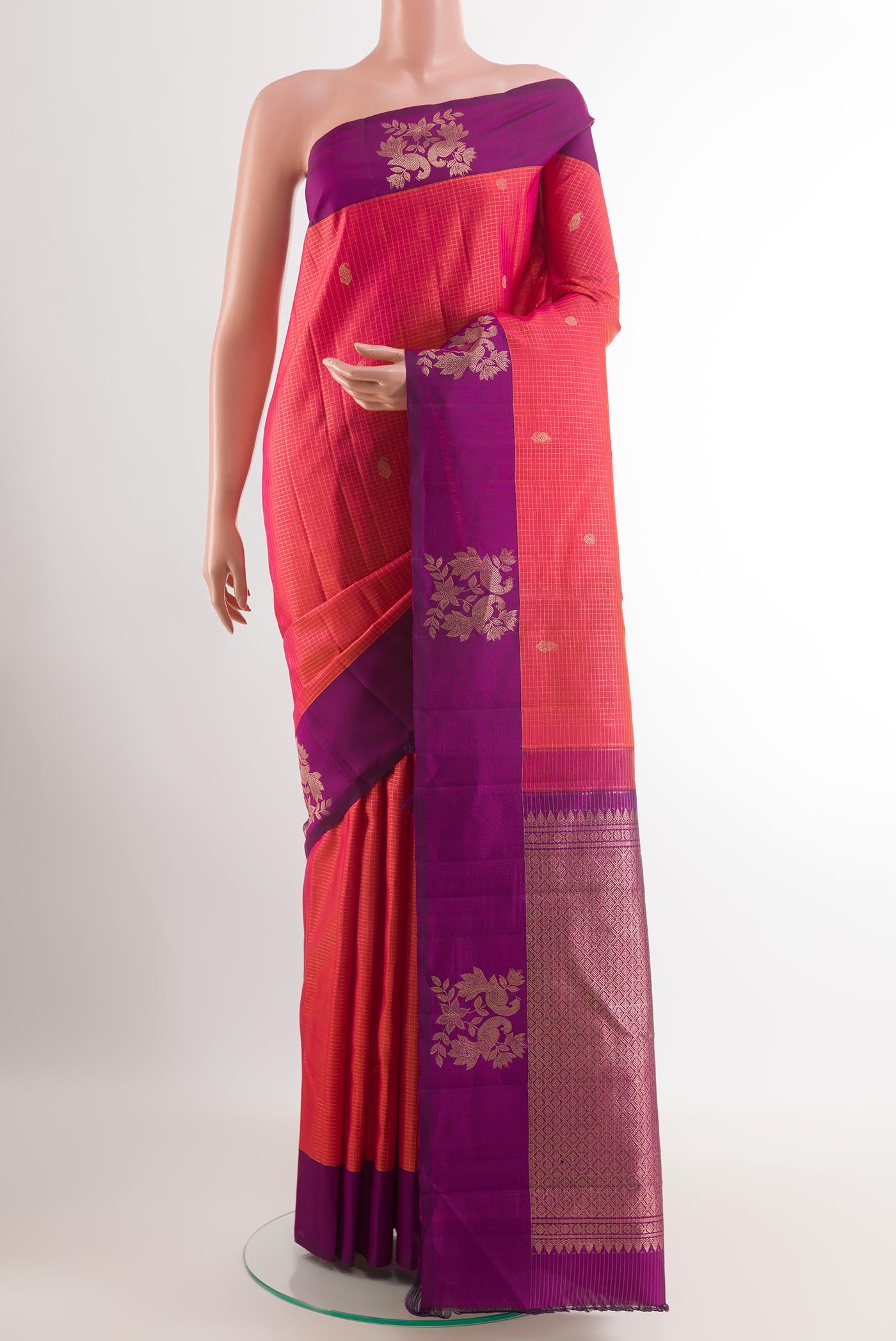 Pink Kanjivaram Silk Saree with Checked design on the body and Zari Border.  displayed on a mannequin