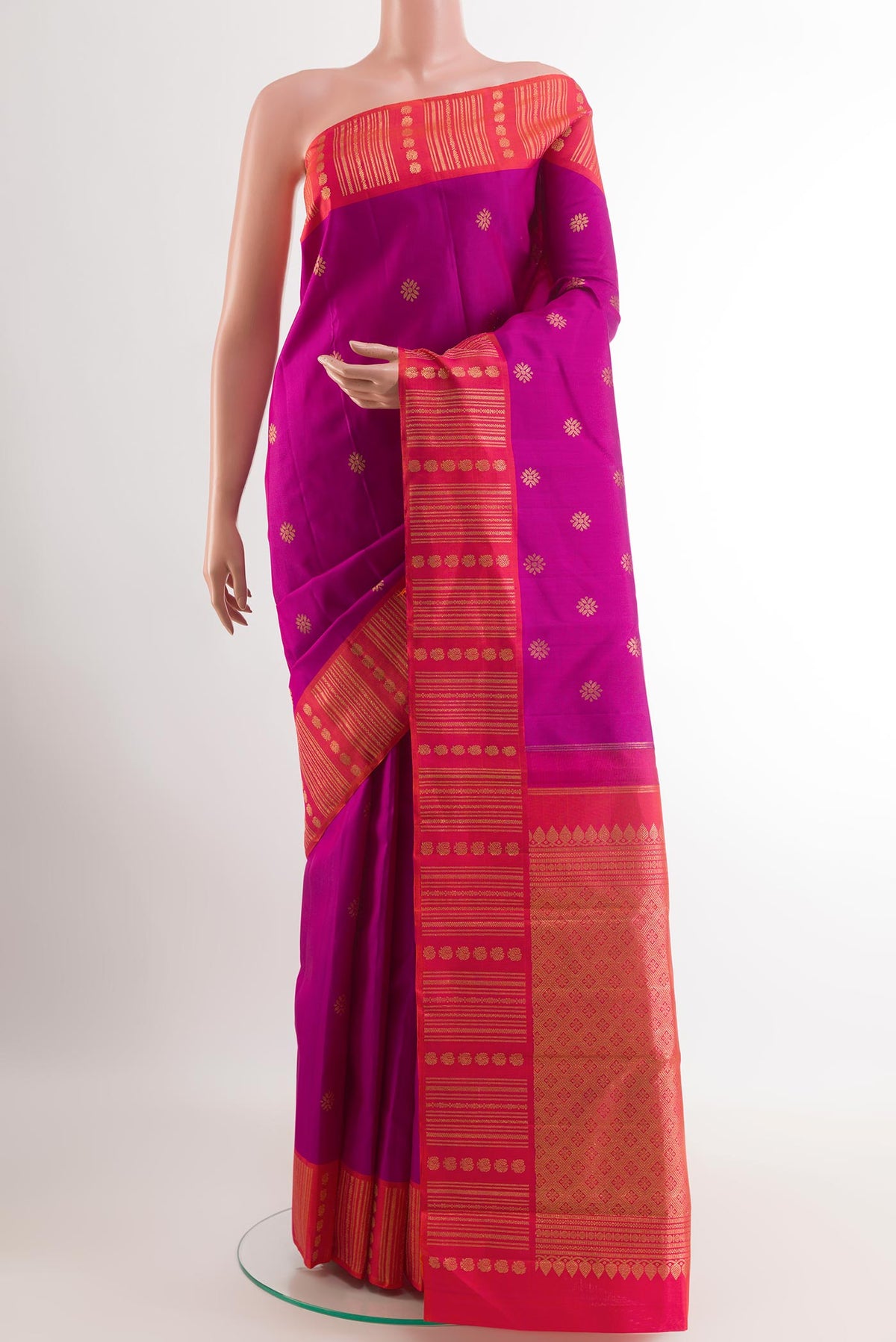 Purple Kanjivaram Silk Saree with Zari Butta on the body and Zari Border.  displayed on a mannequin