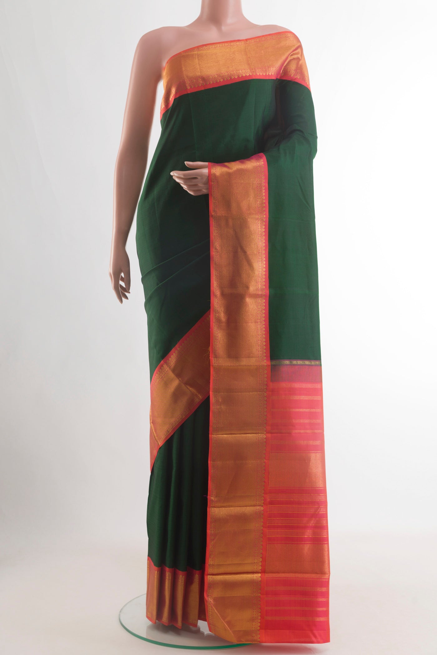 Bottle Green Kanjivaram Silk Saree with Plain Body and Zari Border.  displayed on a mannequin