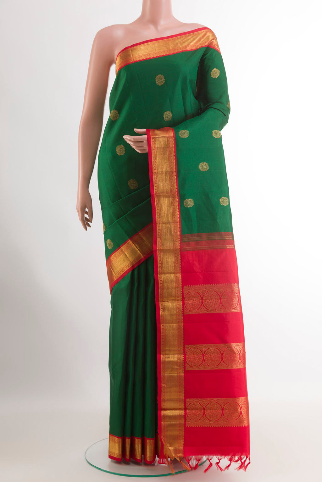 Green Kanchipuram Silk Saree with Zari Butta on the body and Zari Border.  displayed on a mannequin