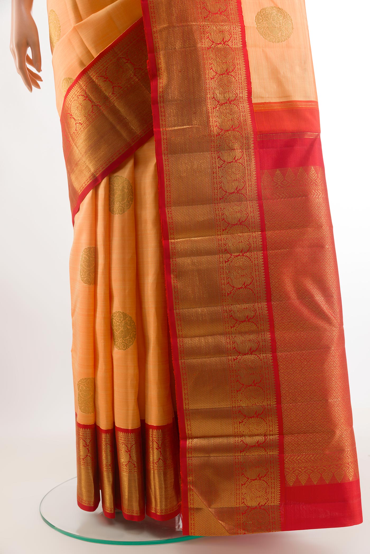 Pleats and pallu of Orange Kanchipuram Silk Saree with Zari Butta on the body and Zari Border. 