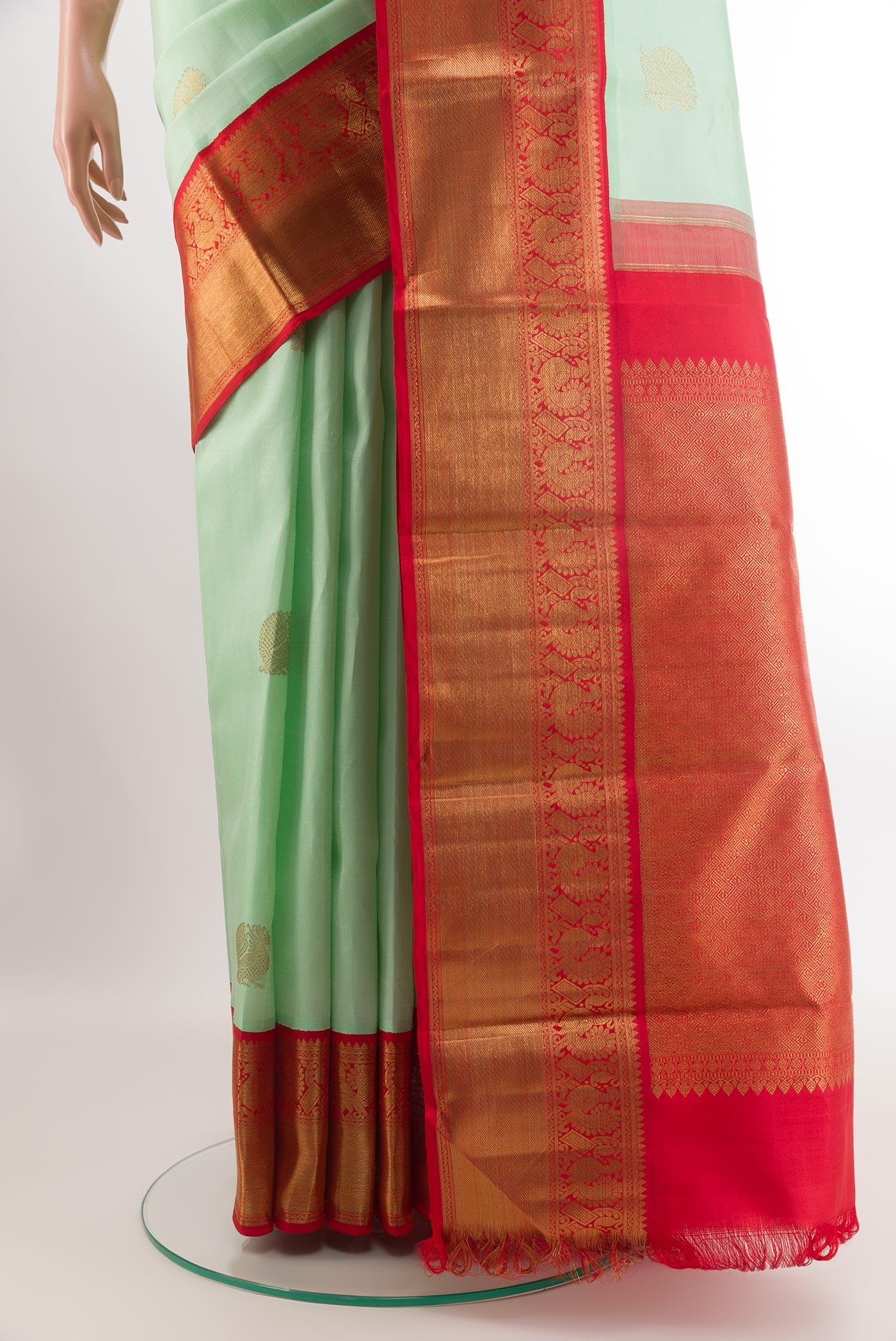 Pleats and pallu of Pista Green Kanchipuram Silk Saree with Zari Butta on the body and Zari Border. 
