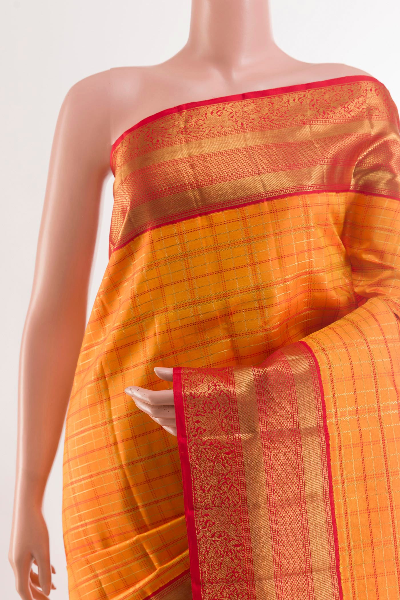Border image of Orange Kanchipuram Silk Saree with Checked design on the body and Ganga Jamuna Border. 