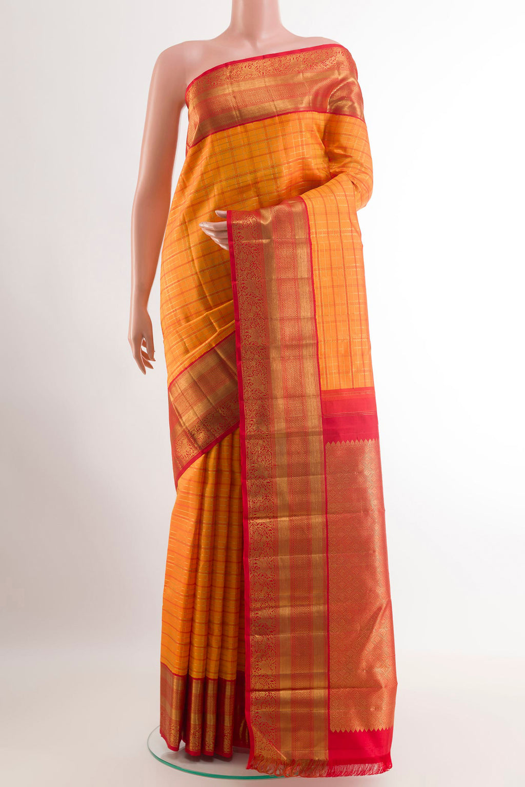 Orange Kanchipuram Silk Saree with Checked design on the body and Ganga Jamuna Border.  displayed on a mannequin