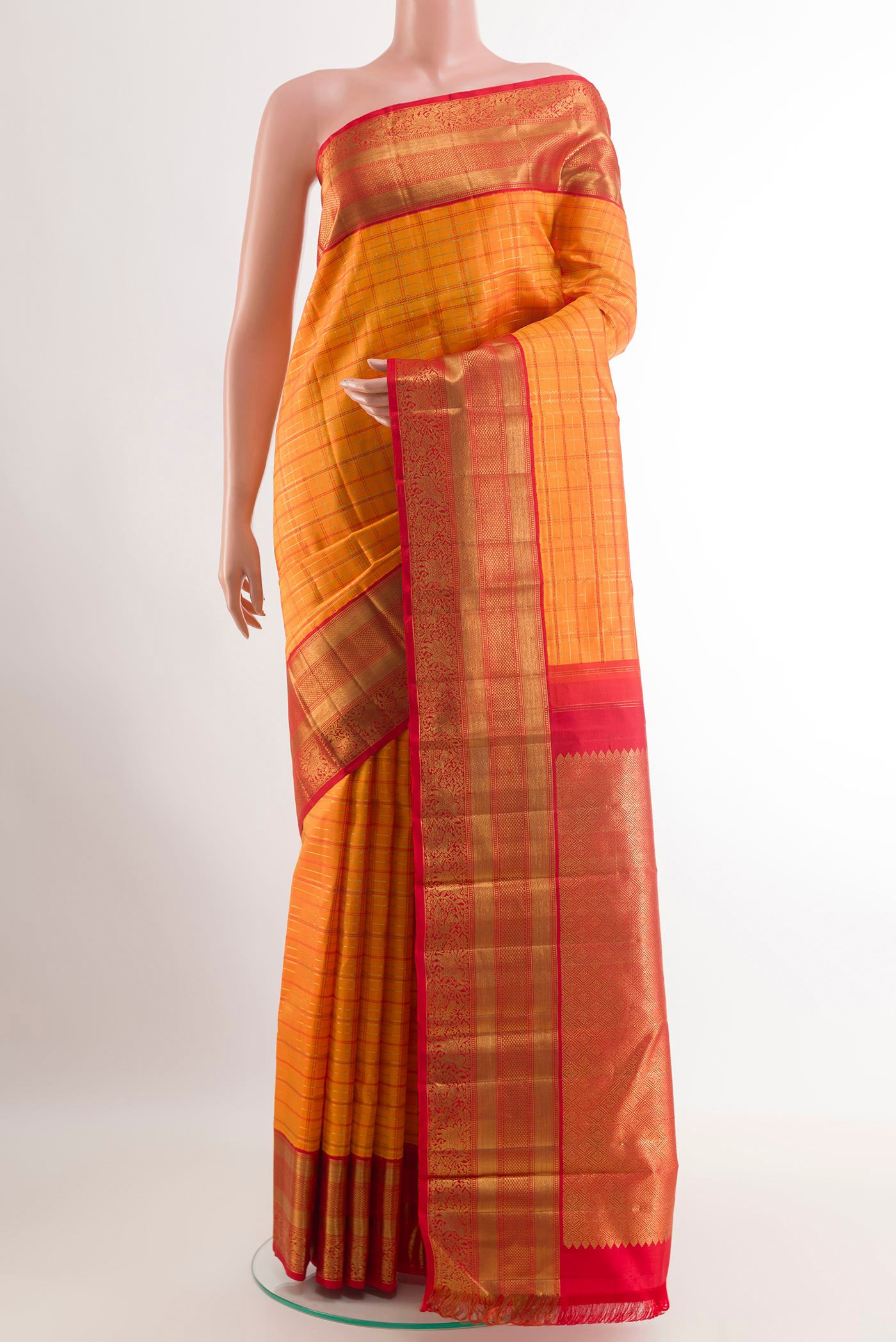 Orange Kanchipuram Silk Saree with Checked design on the body and Ganga Jamuna Border.  displayed on a mannequin