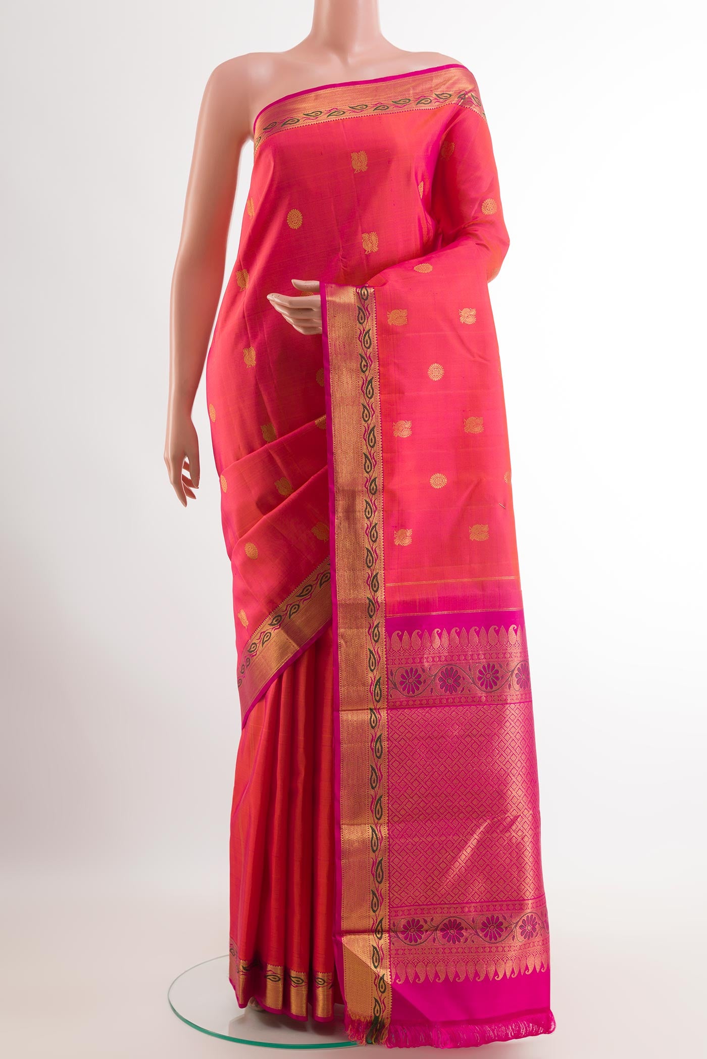 Pink Kanchipuram Silk Saree with Zari Butta on the body and Zari Border.  displayed on a mannequin