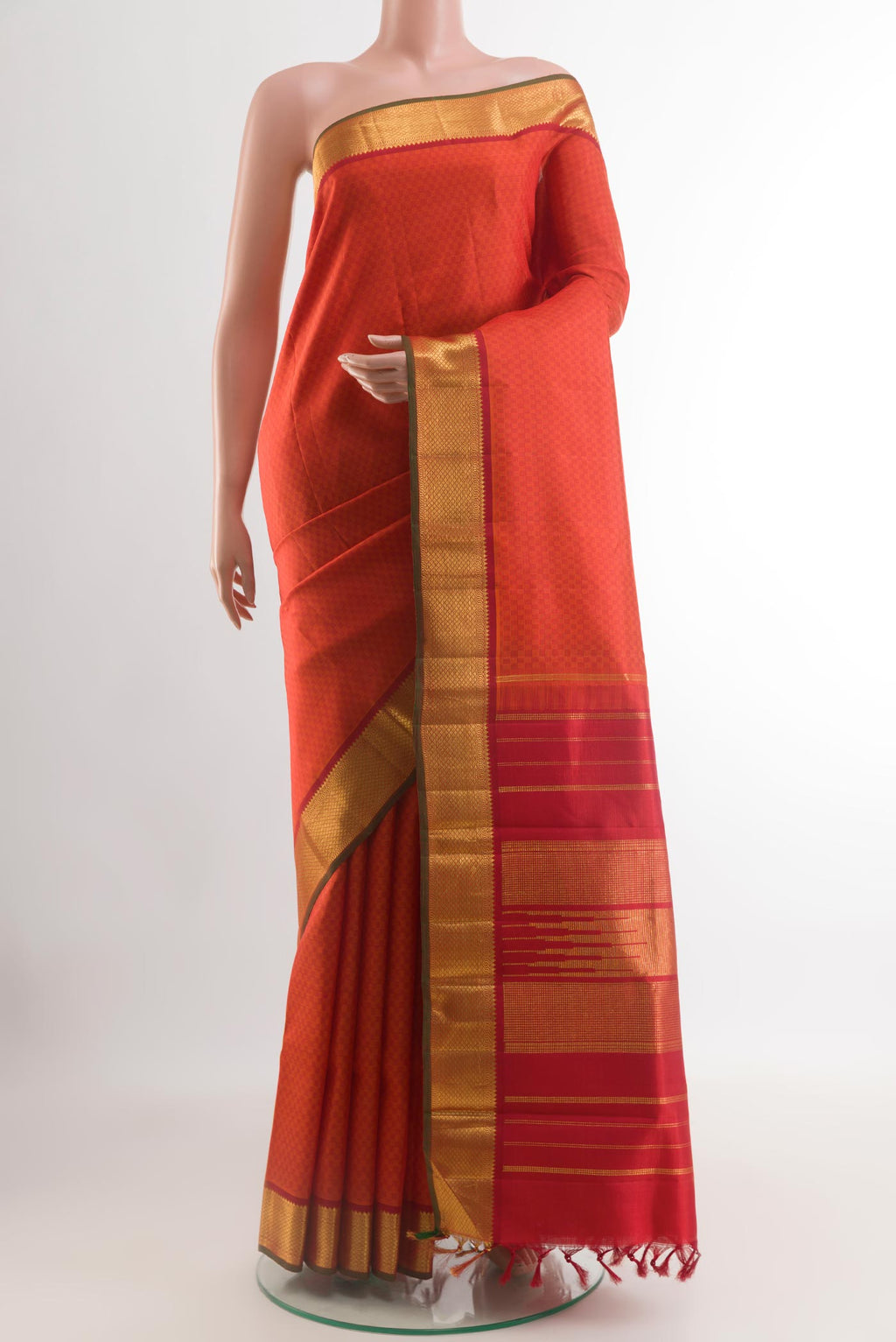 Brick Orange Kanchipuram Silk Saree with Jacquard design on the body and Zari Border.  displayed on a mannequin