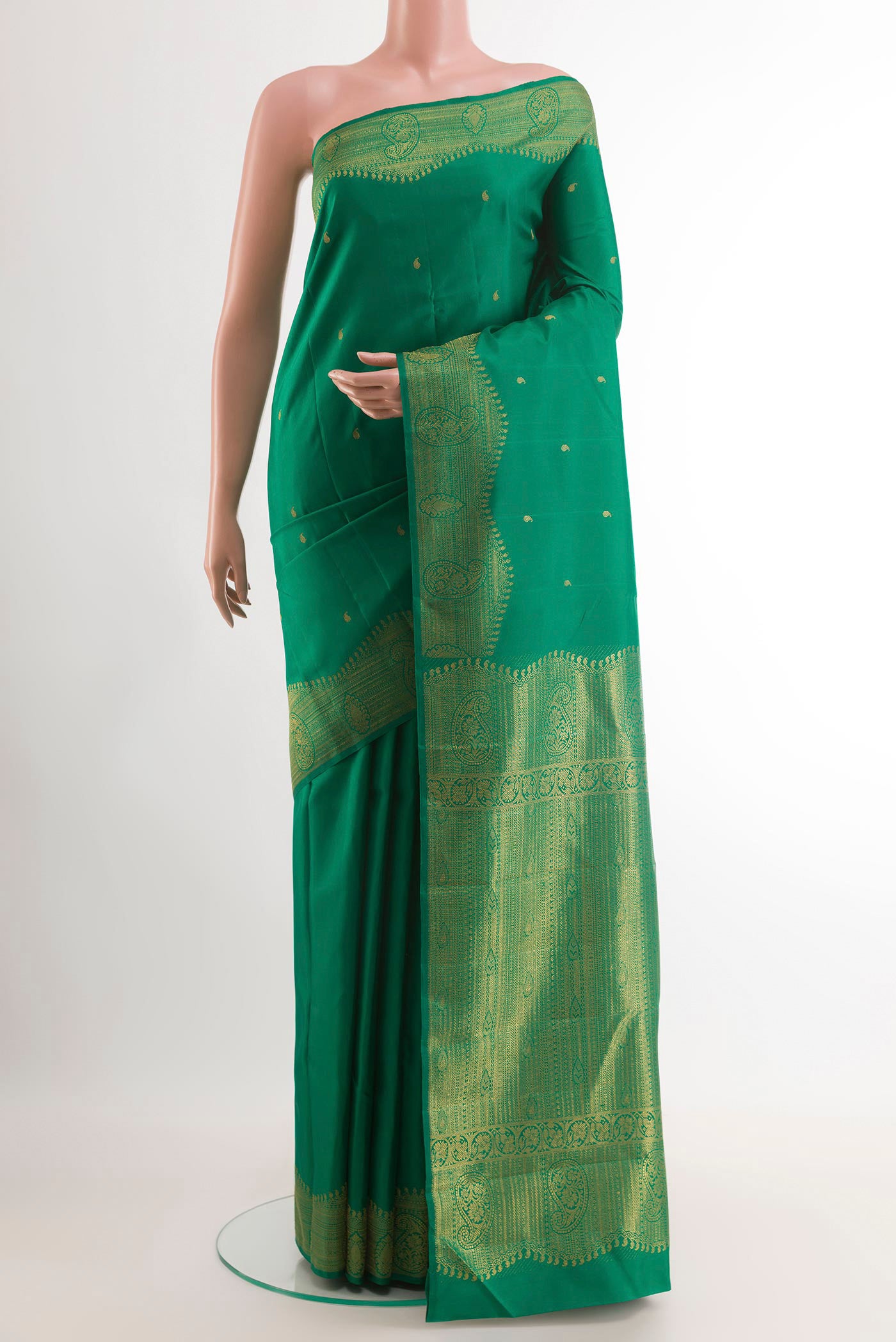 Green Kanjivaram Silk Saree with Zari Butta on the body and Zari Border.  displayed on a mannequin