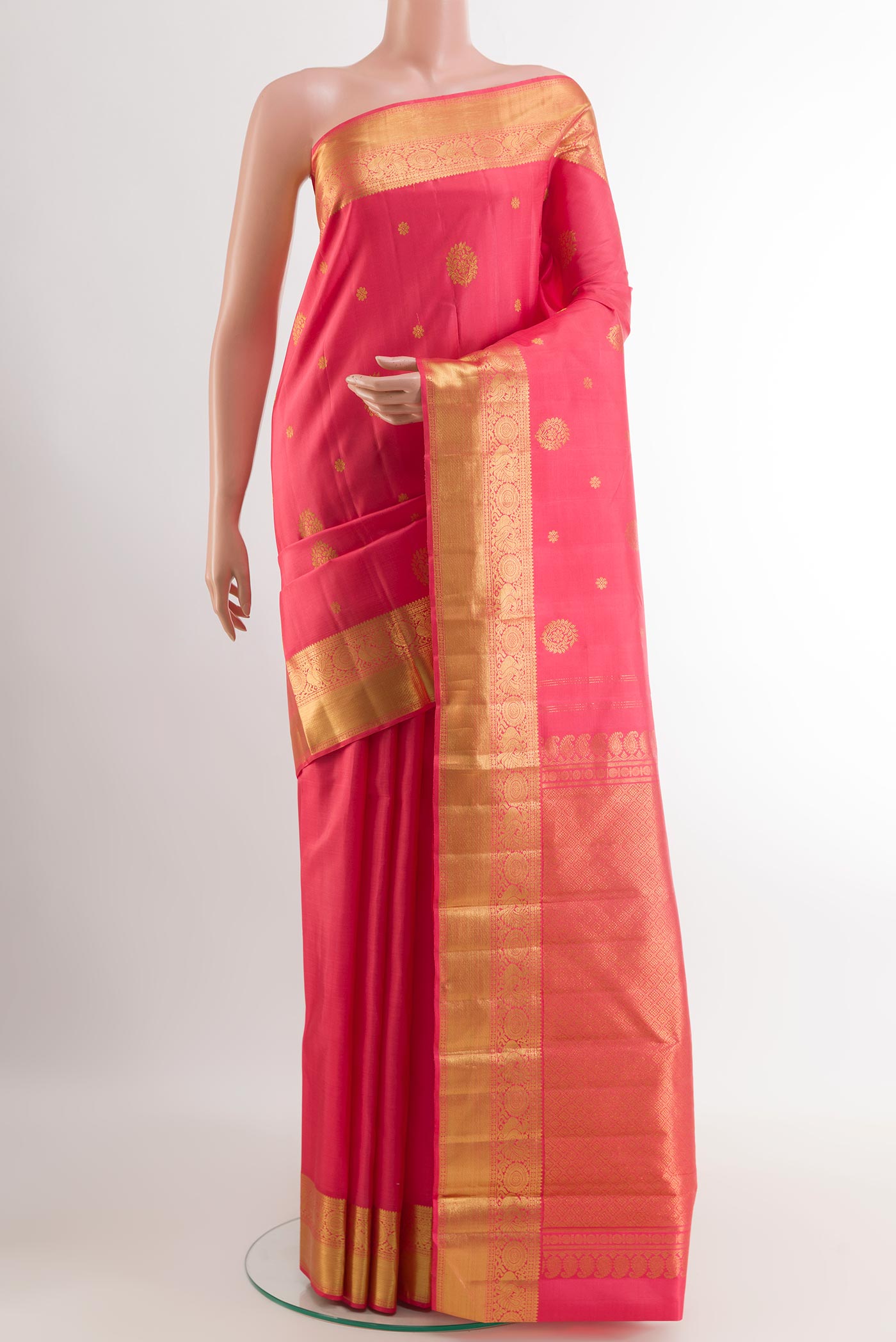 Pink Kanjivaram Silk Saree with Zari Butta on the body and Zari Border.  displayed on a mannequin
