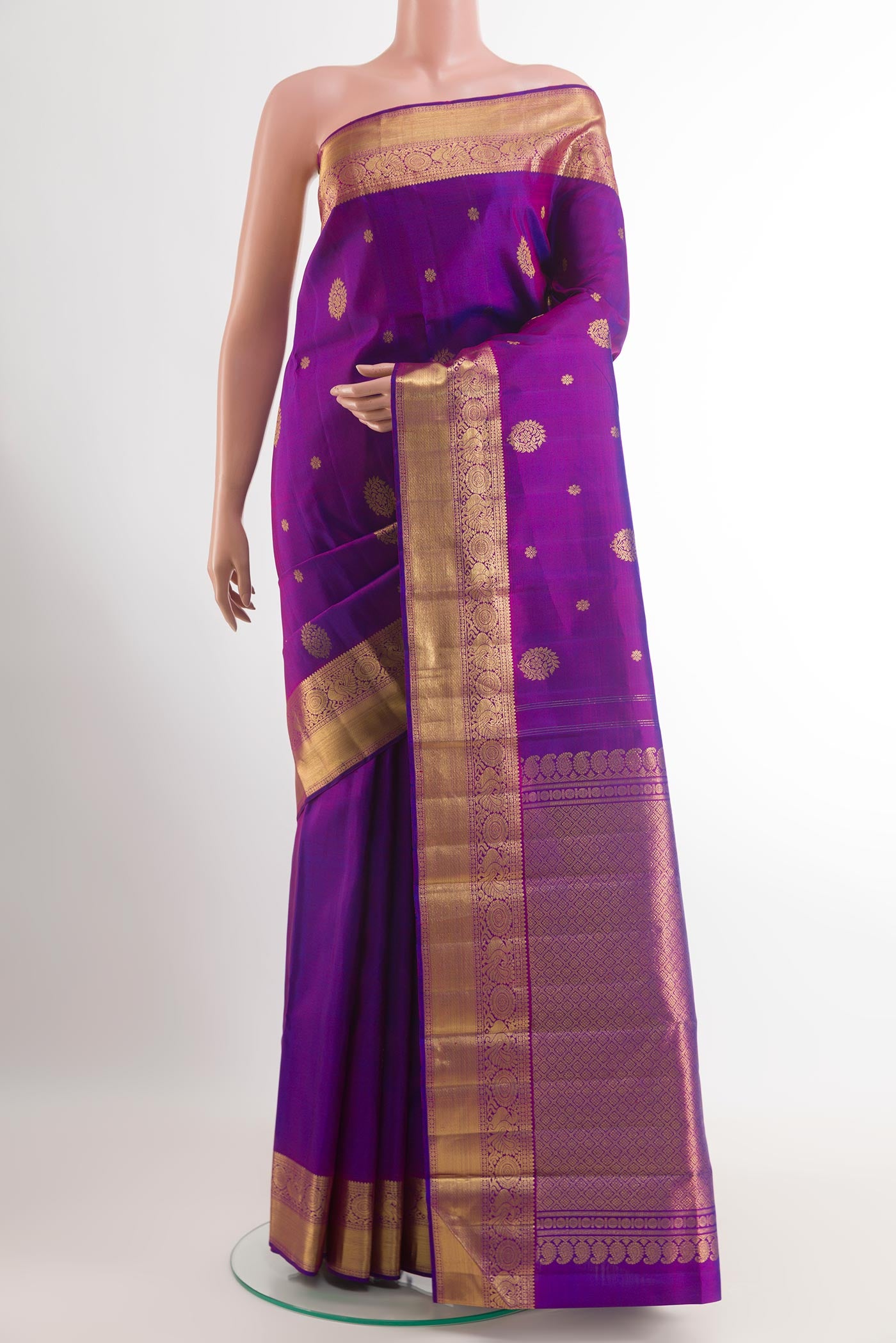 Purple Kanjivaram Silk Saree with Zari Butta on the body and Zari Border.  displayed on a mannequin