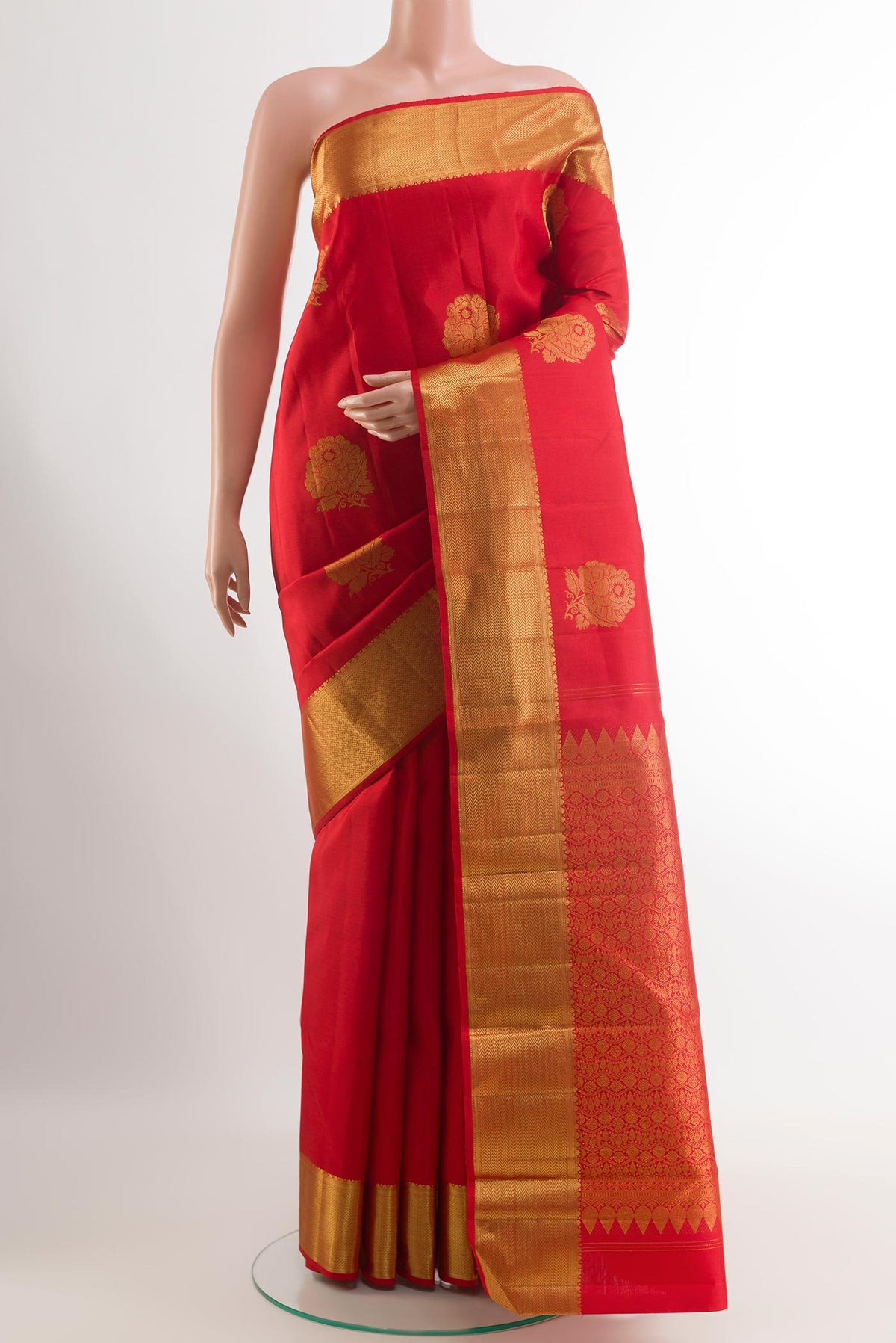 Red Kanjivaram Silk Saree with Zari Butta on the body and Zari Border.  displayed on a mannequin