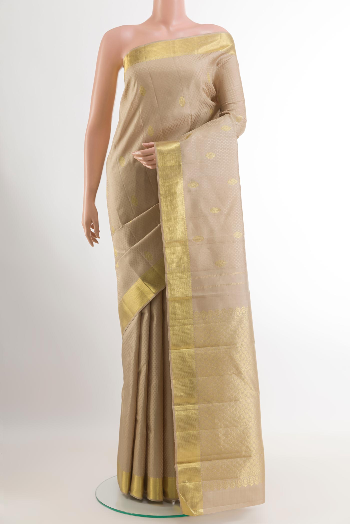 Cream Kanjivaram Silk Saree with Jacquard With Zari Butta on the body and Zari Border.  displayed on a mannequin