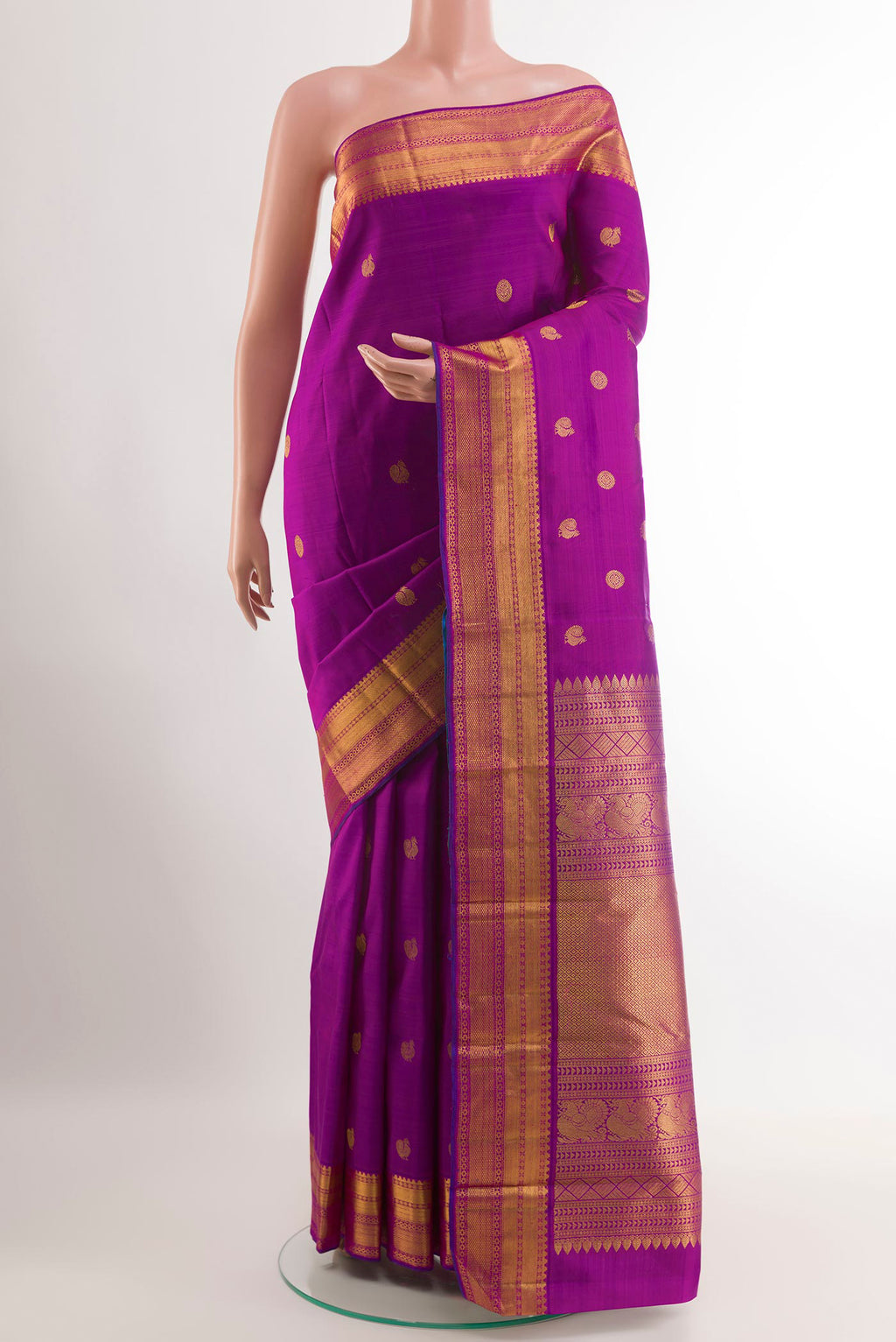 Purple Kanjivaram Silk Saree with Zari Butta on the body and Zari Border.  displayed on a mannequin