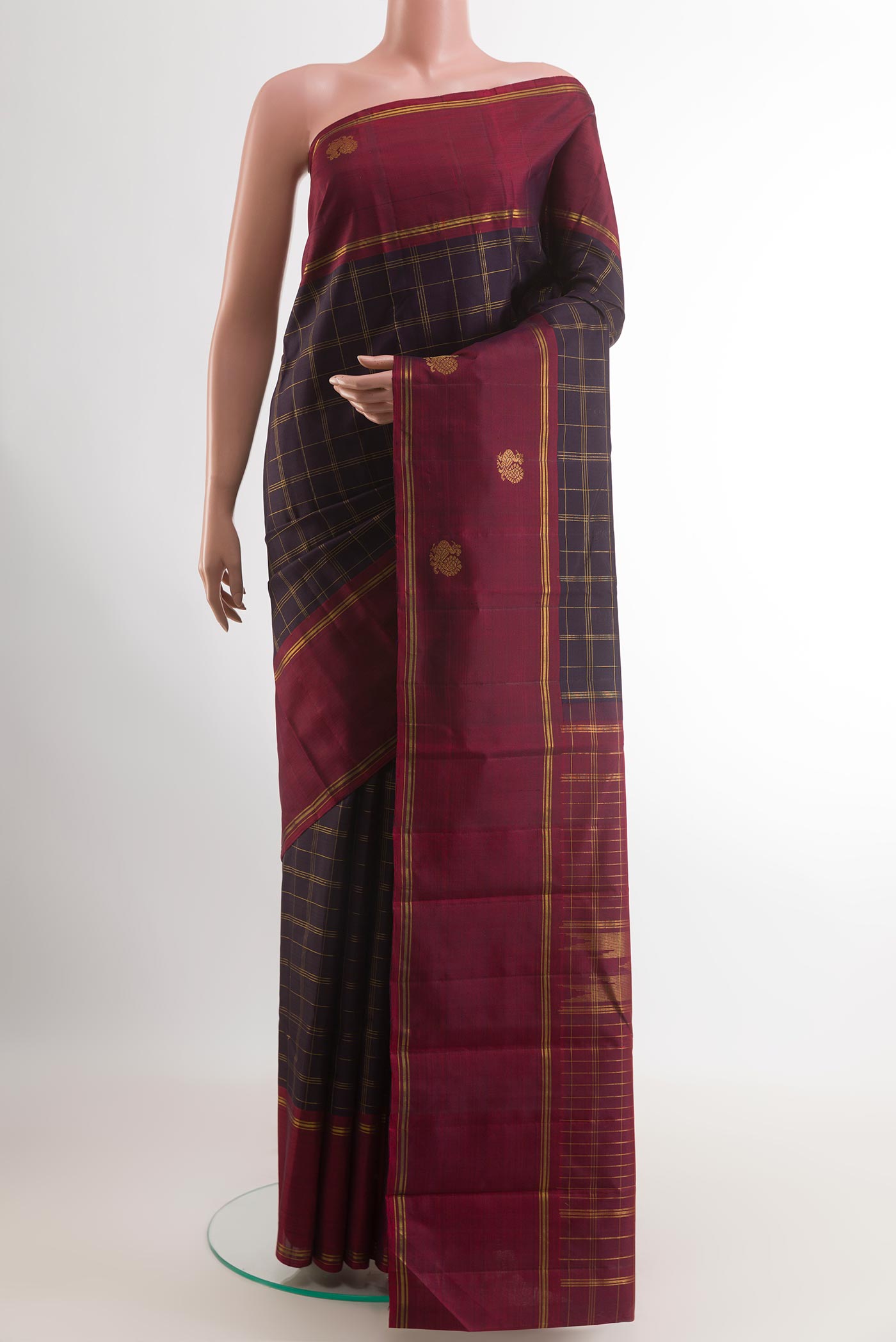 Black Kanchipuram Silk Saree with Checked design on the body and Zari Border.  displayed on a mannequin