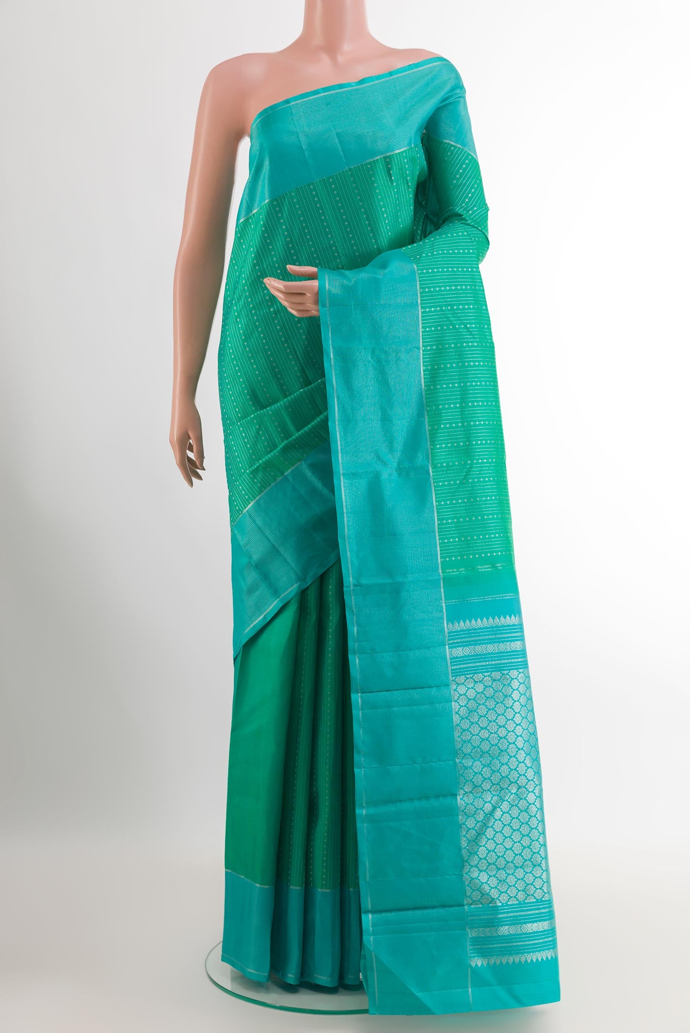 Sea Green Kanchipuram Silk Saree with Stripes on the body and Zari Border.  displayed on a mannequin