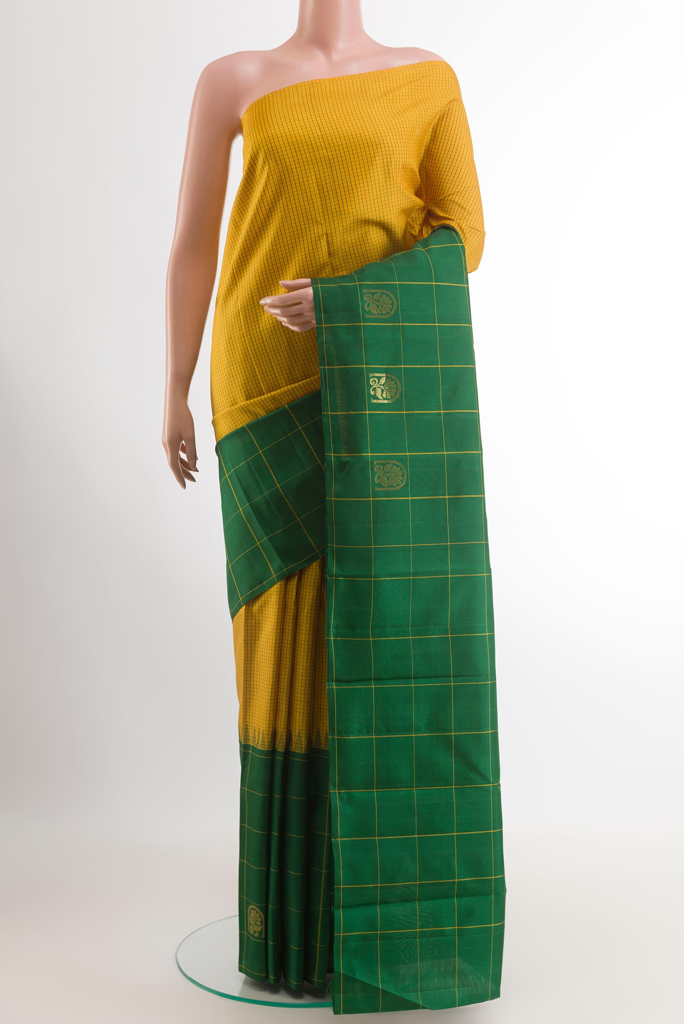Yellow Kanchipuram Silk Saree with Checked design on the body and Zari Border.  displayed on a mannequin