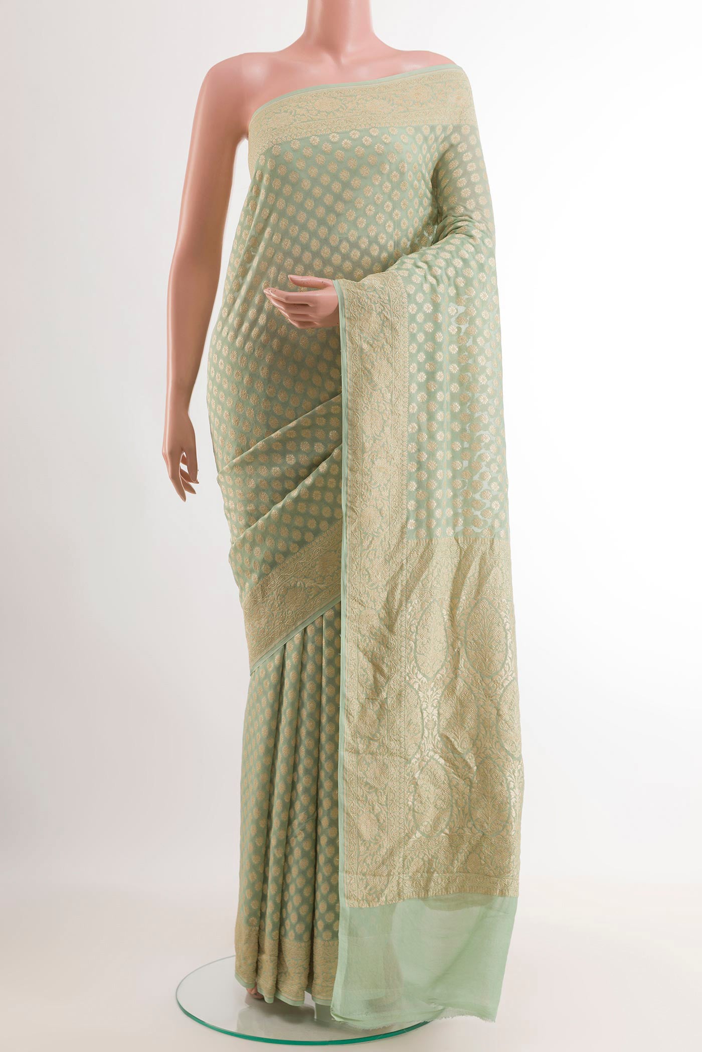 Mint Green Banarasi Georgette Saree with Zari Butta on the body and Zari Border.  displayed on a mannequin
