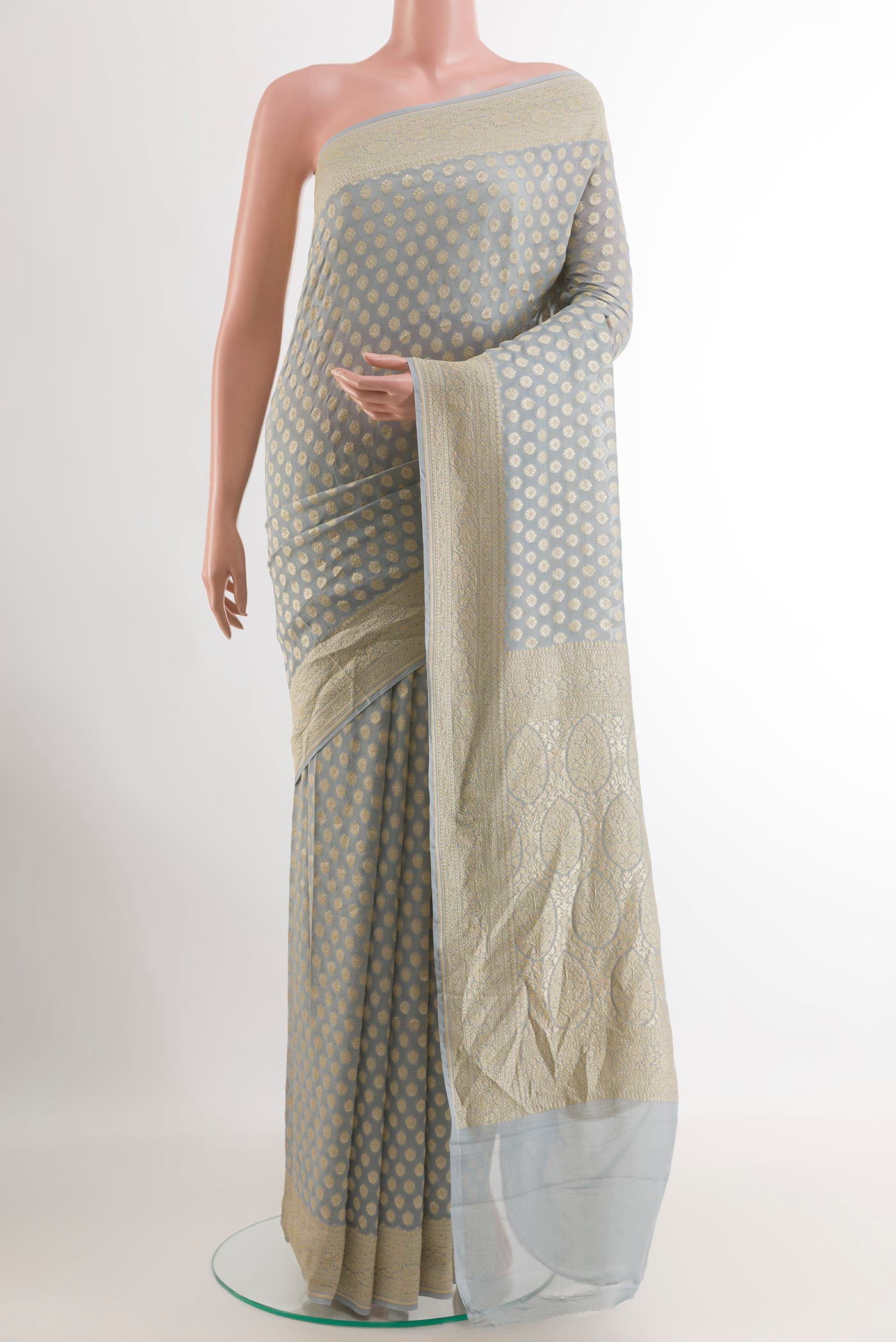 Grey Banarasi Georgette Saree with Zari Butta on the body and Zari Border.  displayed on a mannequin