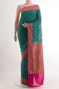 Sea Green Banarasi Georgette Saree with Zari Brocade on the body and Zari Border.  displayed on a mannequin