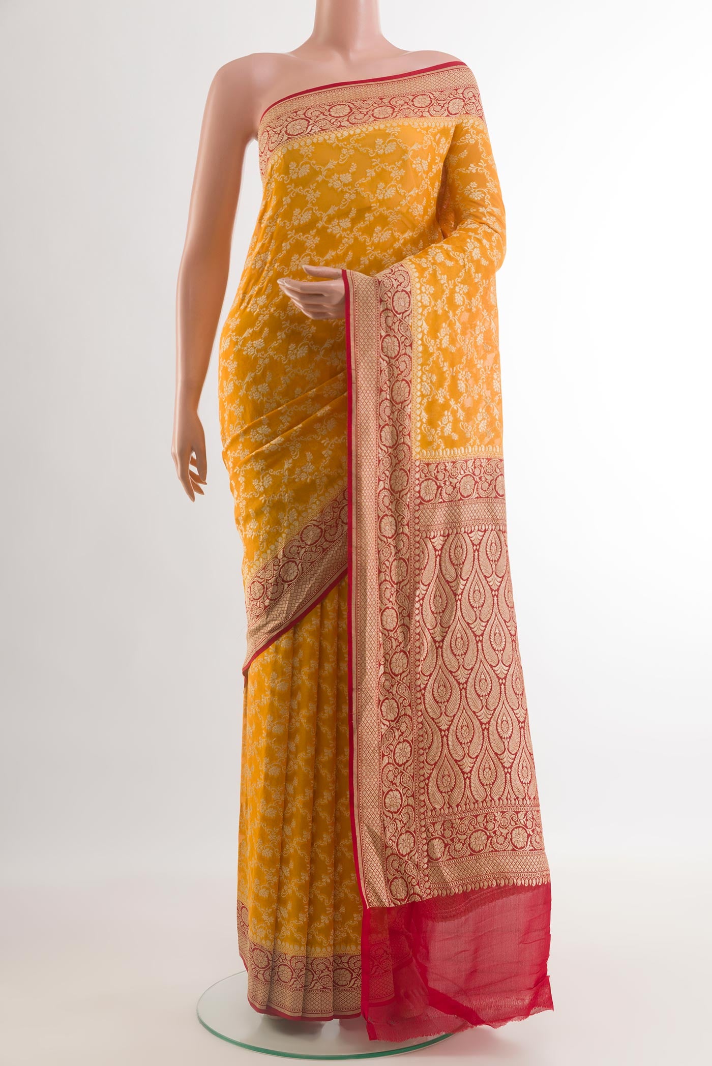 Yellow Banarasi Georgette Saree with Zari Brocade on the body and Zari Border.  displayed on a mannequin