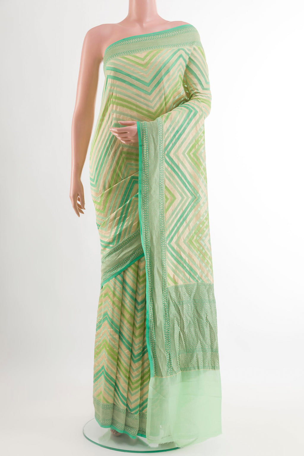 Green Banarasi Georgette Saree with Zari Brocade on the body and Zari Border.  displayed on a mannequin
