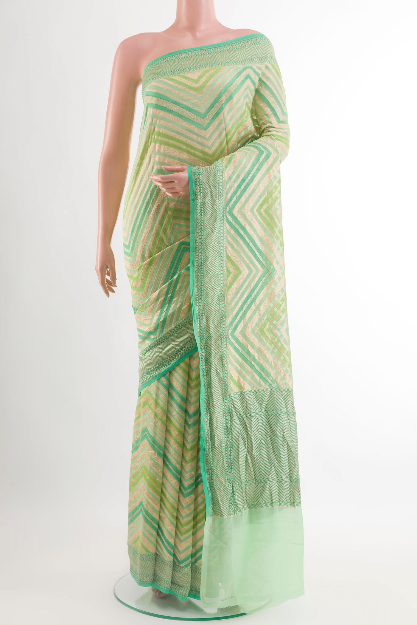 Green Banarasi Georgette Saree with Zari Brocade on the body and Zari Border.  displayed on a mannequin