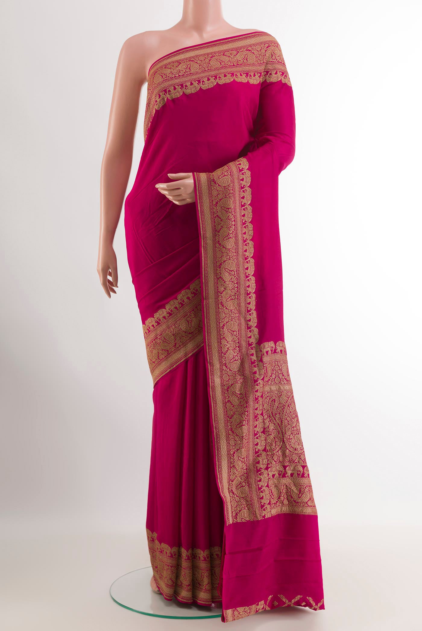 Rani Pink Banarasi Georgette Saree with Plain Body and Zari Border.  displayed on a mannequin