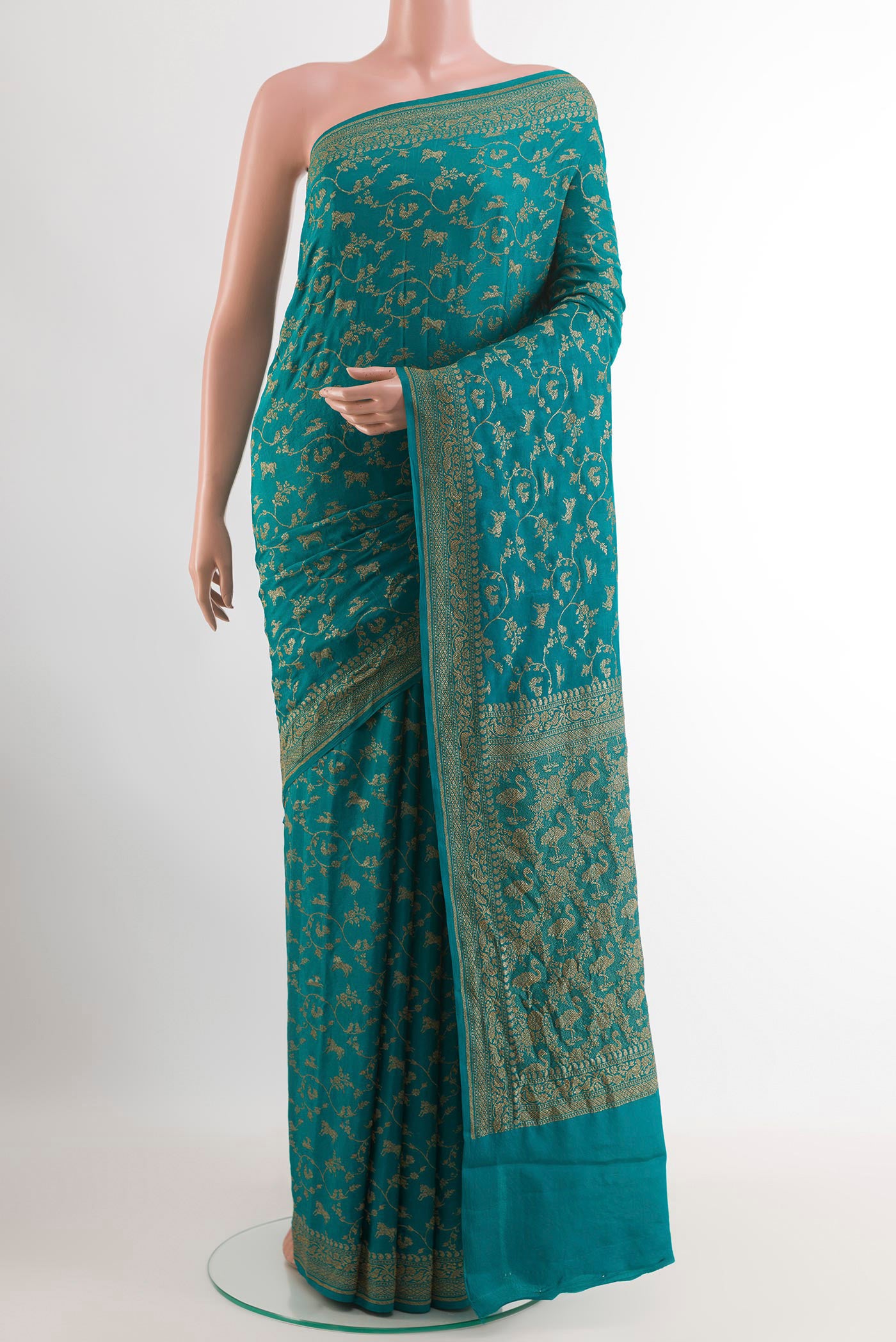 Teal Banarasi Georgette Saree with Zari Brocade on the body and Zari Border.  displayed on a mannequin
