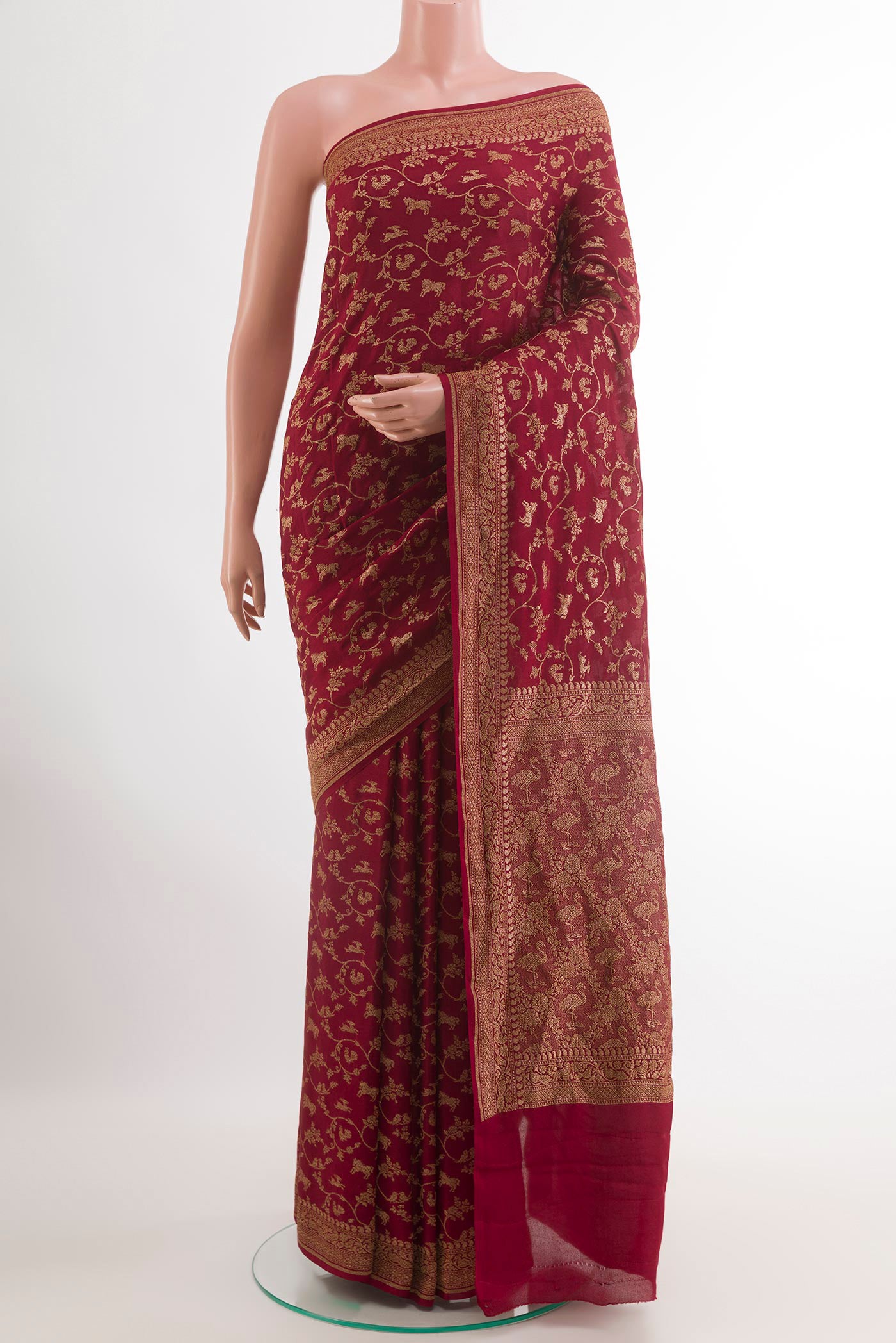 Maroon Banarasi Georgette Saree with Zari Brocade on the body and Zari Border.  displayed on a mannequin