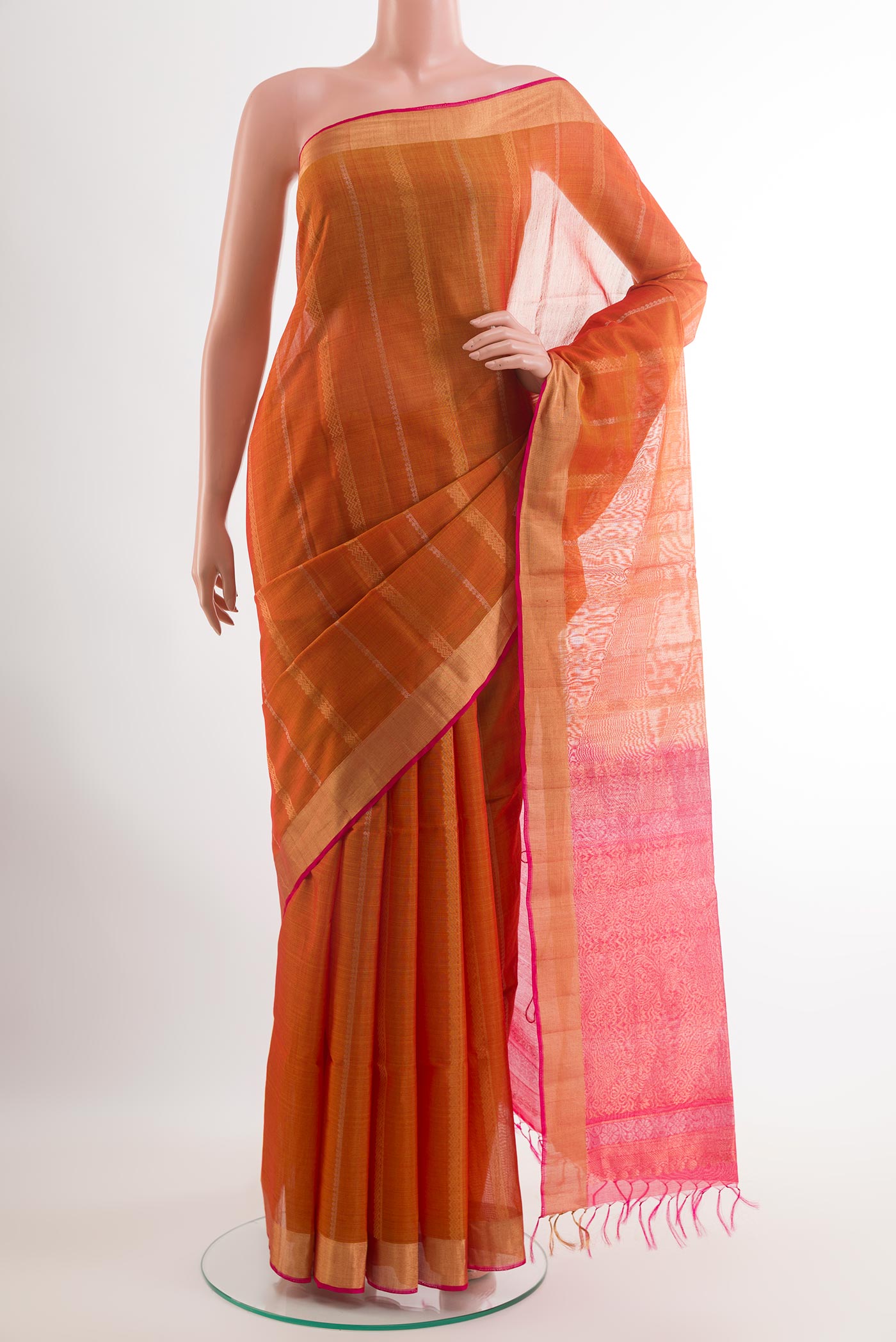Orange Blended Kora Cotton Saree with Stripes on the body and Zari Border.  displayed on a mannequin