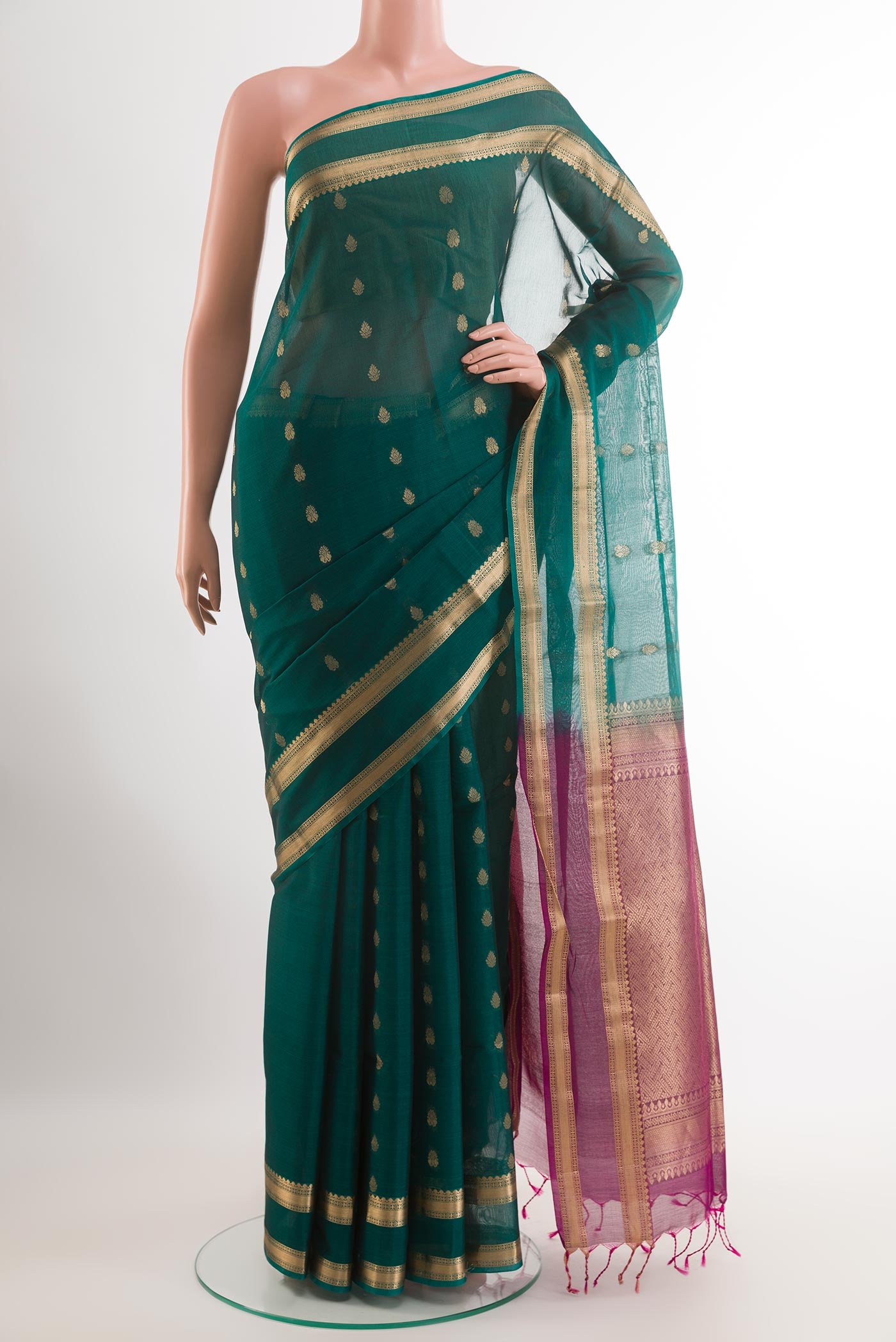 Bottle Green Blended Kora Cotton Saree with Zari Butta on the body and Zari Border.  displayed on a mannequin