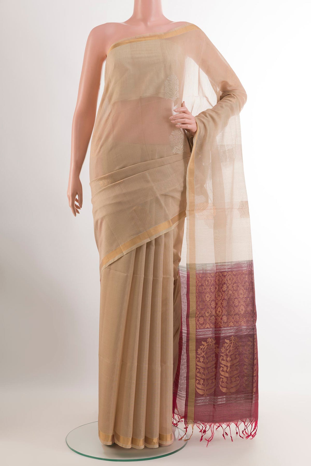 Beige Blended Kora Cotton Saree with Zari Butta on the body and Zari Border.  displayed on a mannequin
