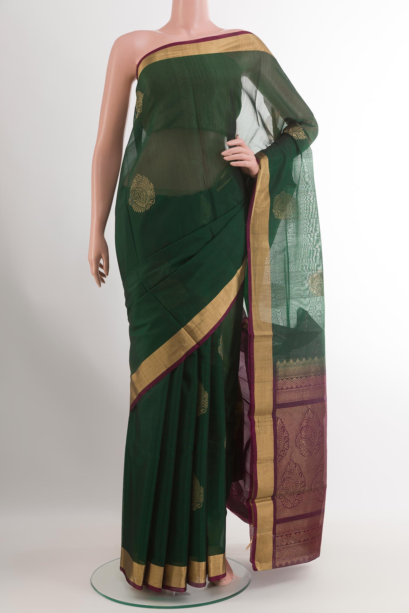 Green Blended Kora Cotton Saree with Zari Butta on the body and Zari Border.  displayed on a mannequin