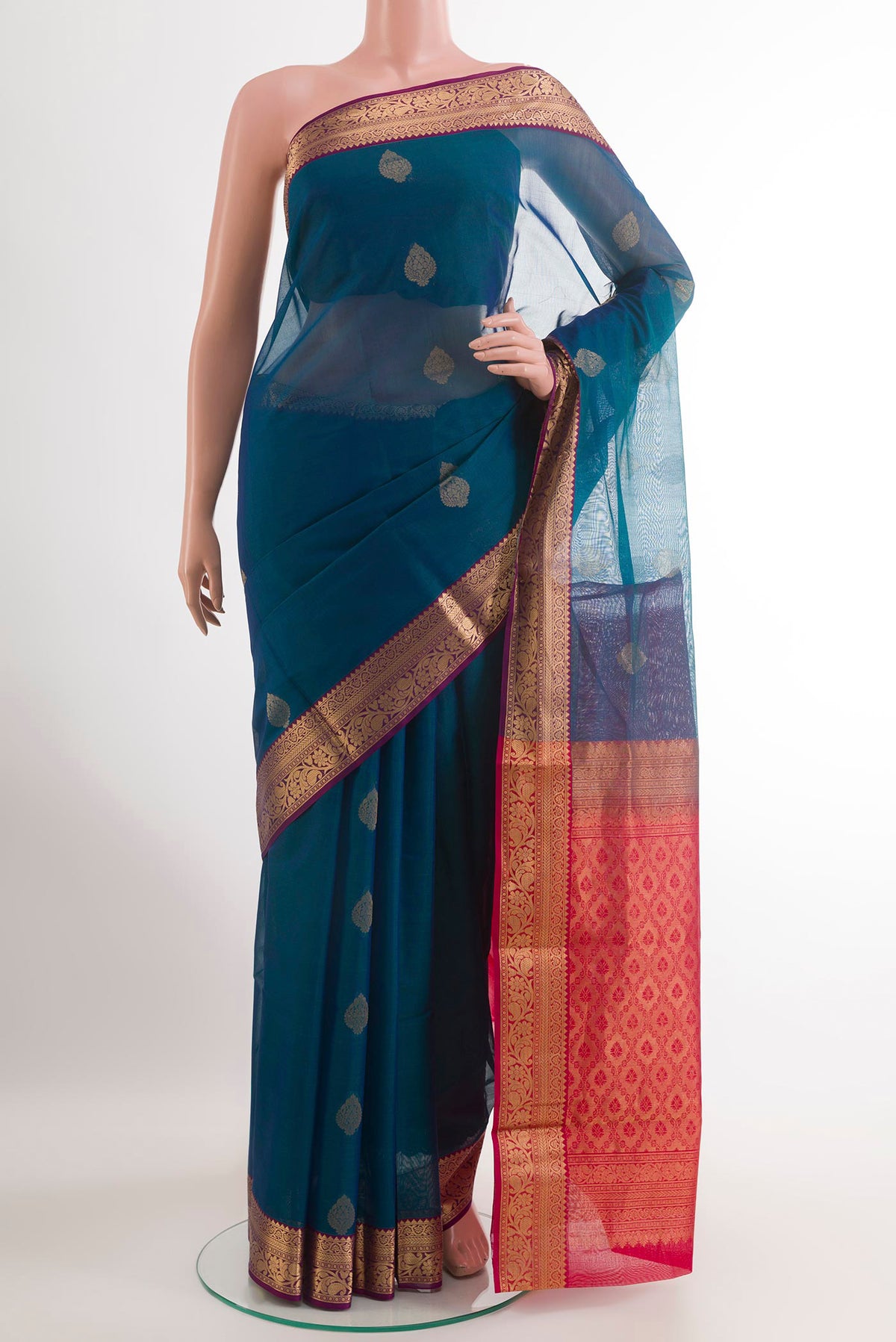 Peacock Blue Blended Kora Cotton Saree with Zari Butta on the body and Zari Border.  displayed on a mannequin