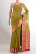 Green Blended Kora Cotton Saree with Zari Butta on the body and Zari Border.  displayed on a mannequin
