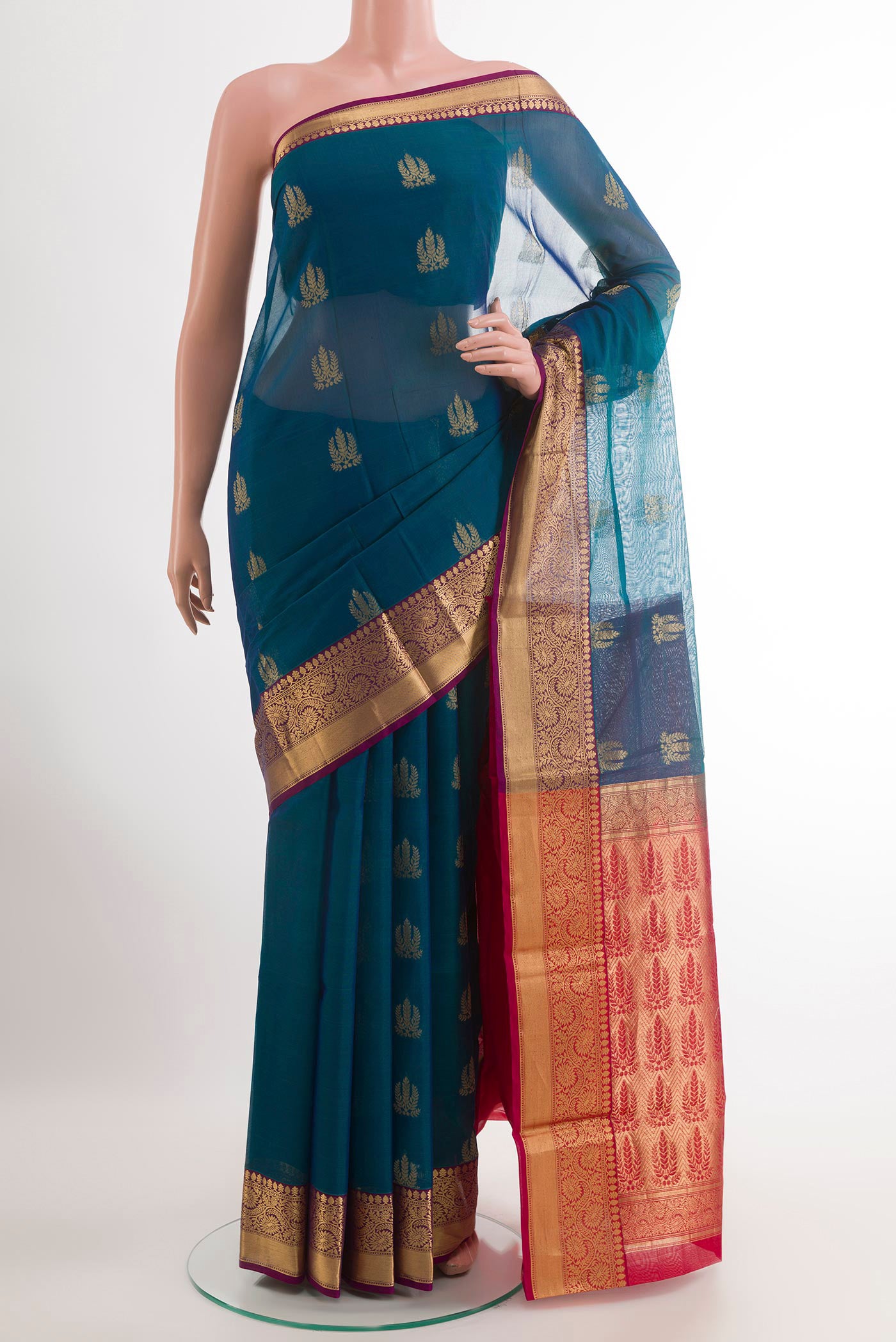 Peacock Blue Blended Kora Cotton Saree with Zari Butta on the body and Zari Border.  displayed on a mannequin