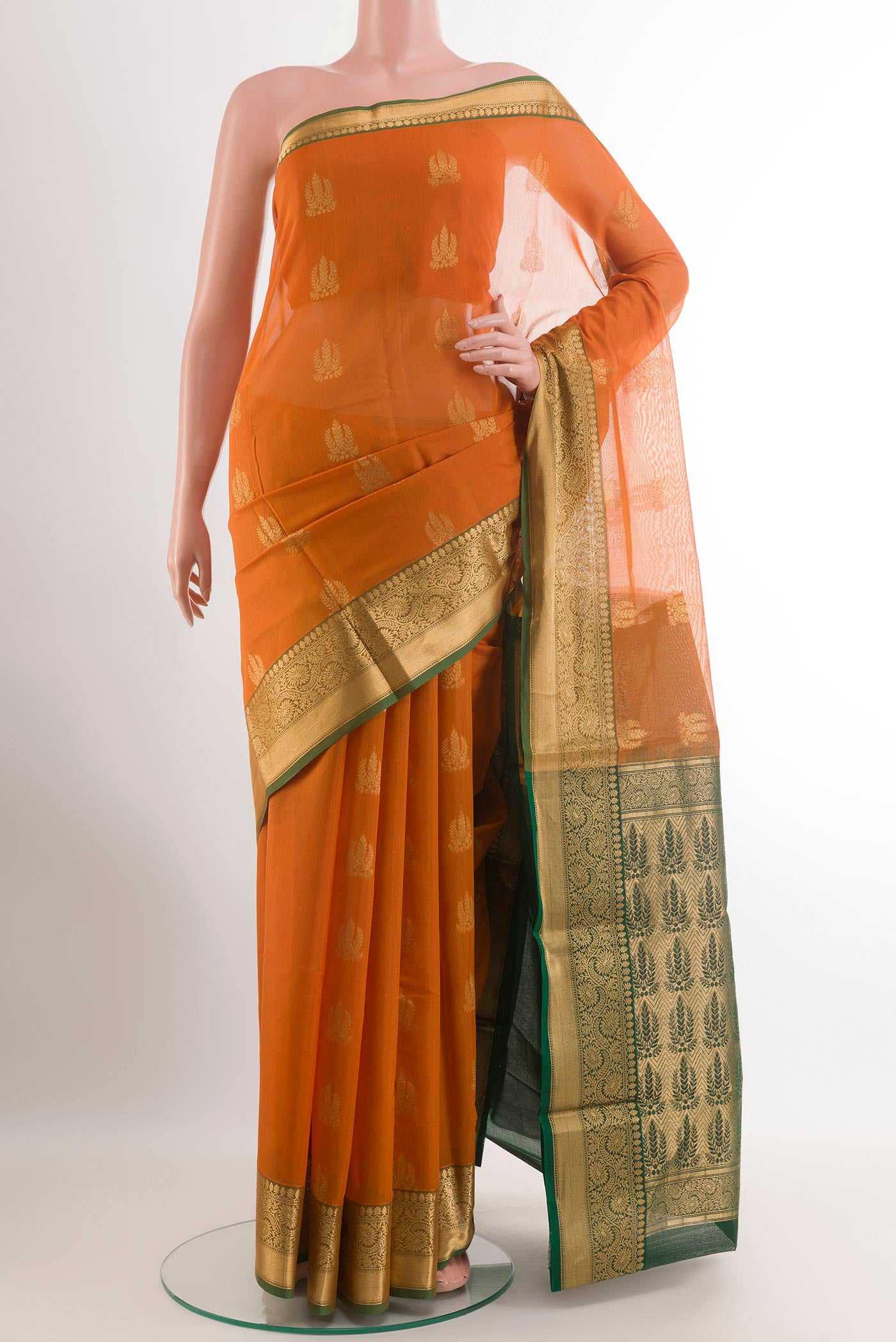 Mustard Blended Kora Cotton Saree with Zari Butta on the body and Zari Border.  displayed on a mannequin