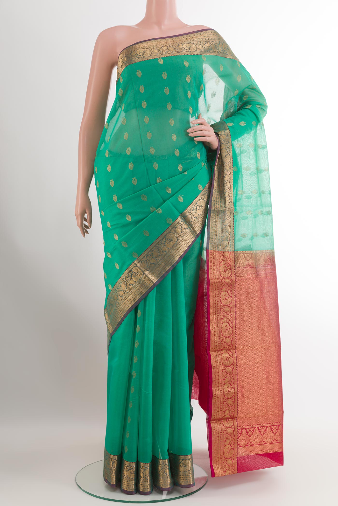 Green Blended Kora Cotton Saree with Zari Butta on the body and Zari Border.  displayed on a mannequin