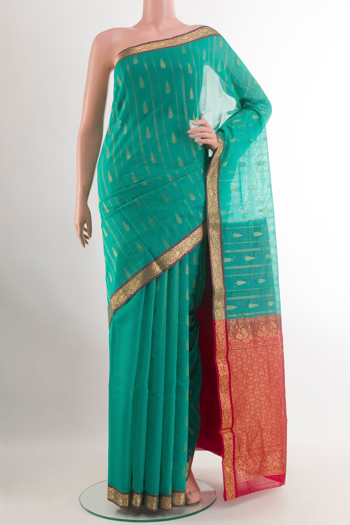 Sea Green Blended Kora Cotton Saree with Zari Butta on the body and Zari Border.  displayed on a mannequin