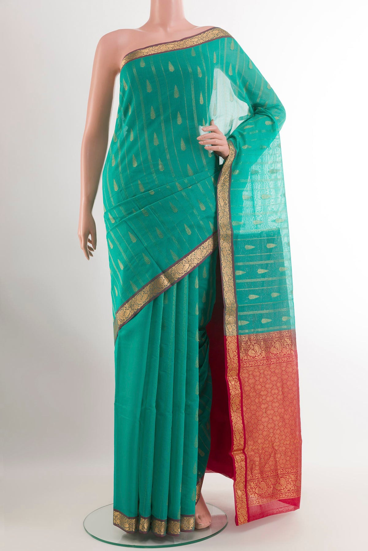 Sea Green Blended Kora Cotton Saree with Zari Butta on the body and Zari Border.  displayed on a mannequin
