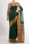 Bottle Green Blended Kora Cotton Saree with Zari Butta on the body and Zari Border.  displayed on a mannequin