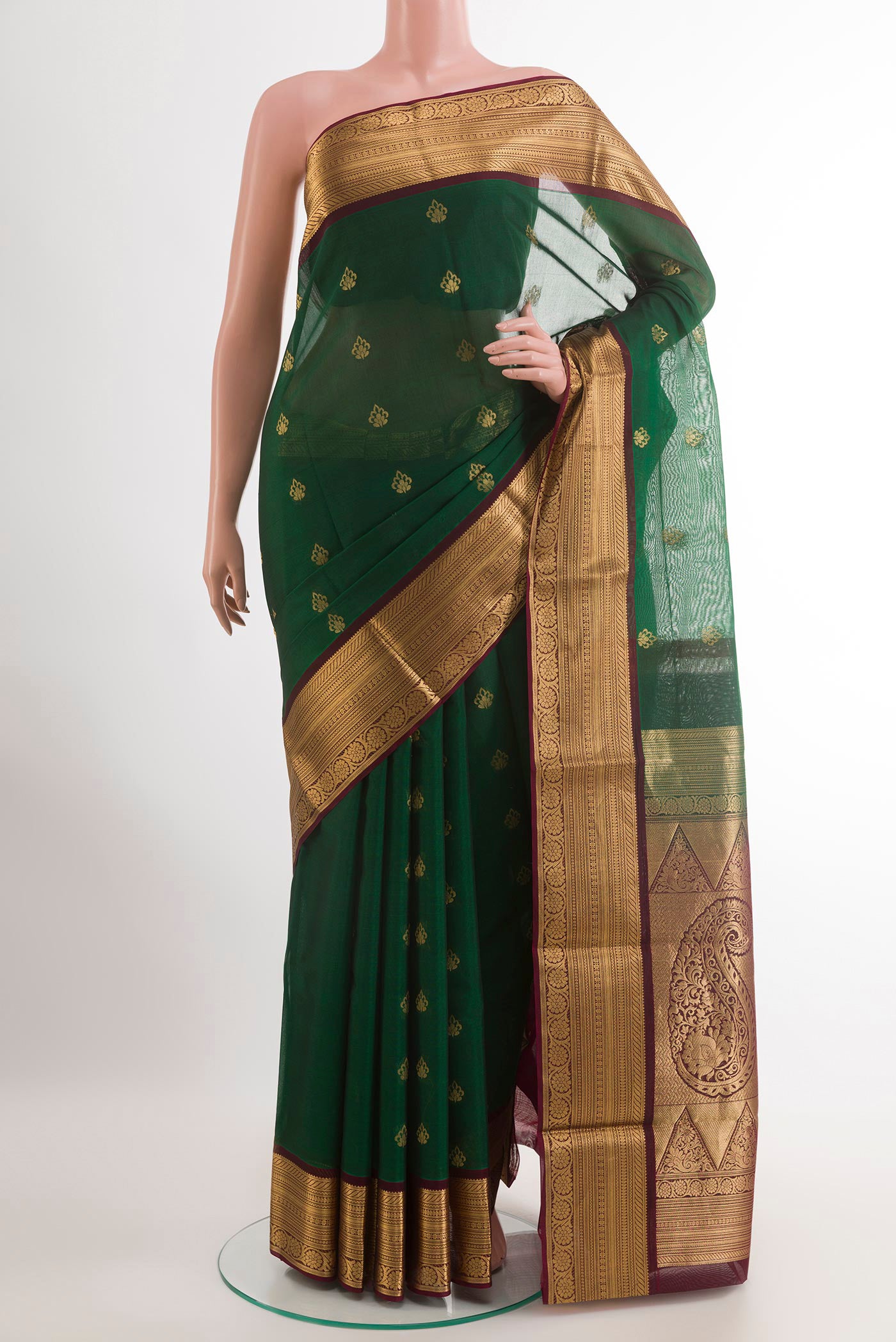 Bottle Green Blended Kora Cotton Saree with Zari Butta on the body and Zari Border.  displayed on a mannequin