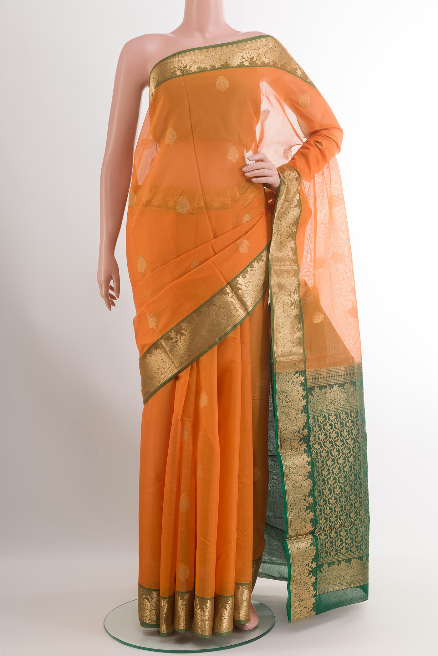 Orange Blended Kora Cotton Saree with Zari Butta on the body and Zari Border.  displayed on a mannequin