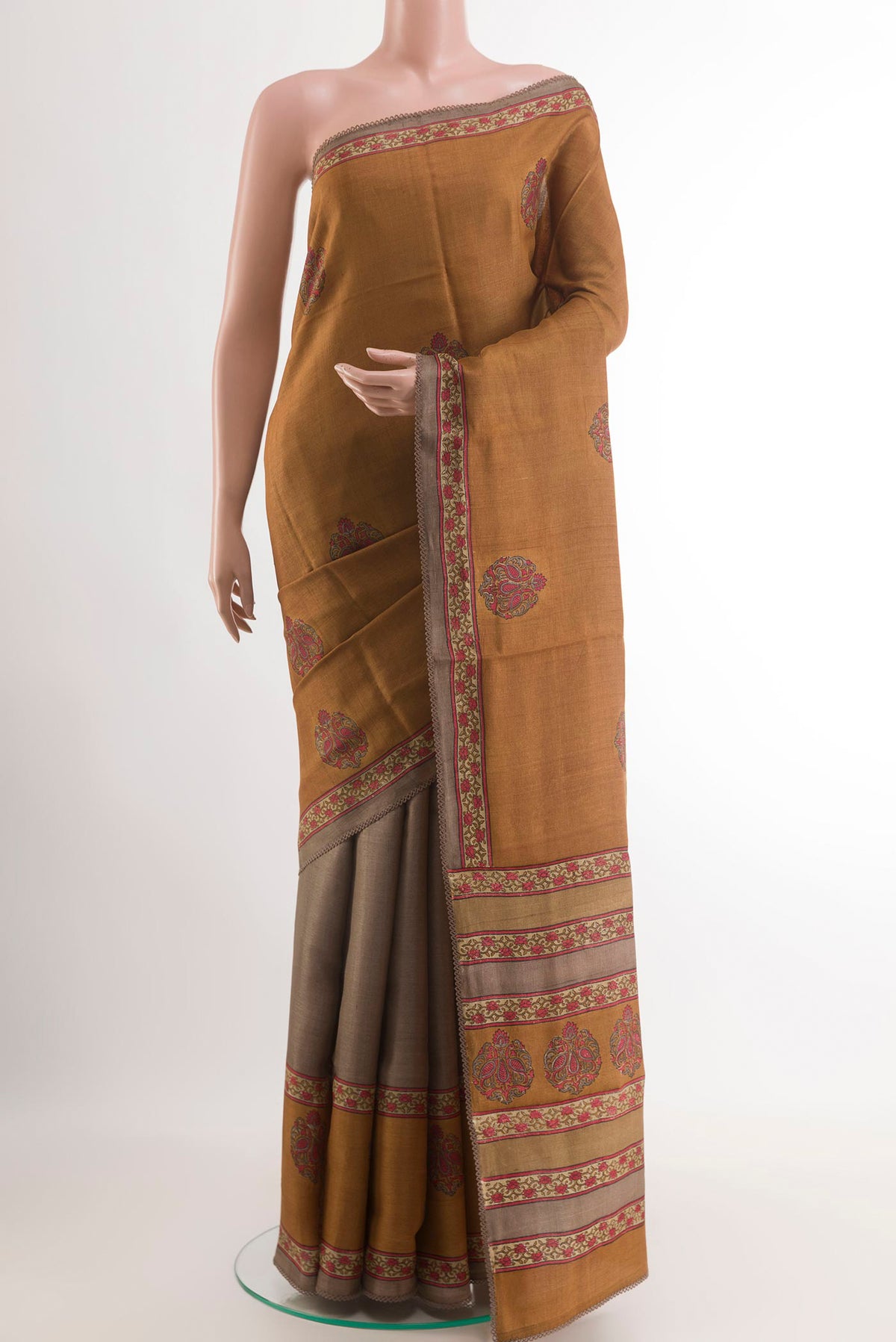 Grey Tussar Saree with Printed design on the body and Printed Border.  displayed on a mannequin