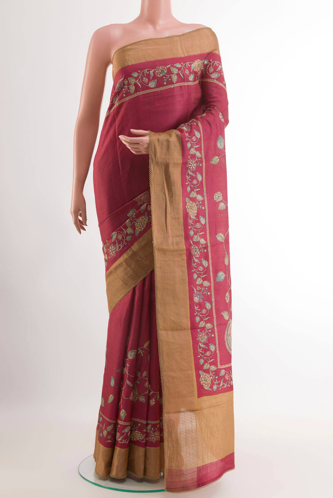 Red Tussar Saree with Embroidery on the body and Zari Border.  displayed on a mannequin